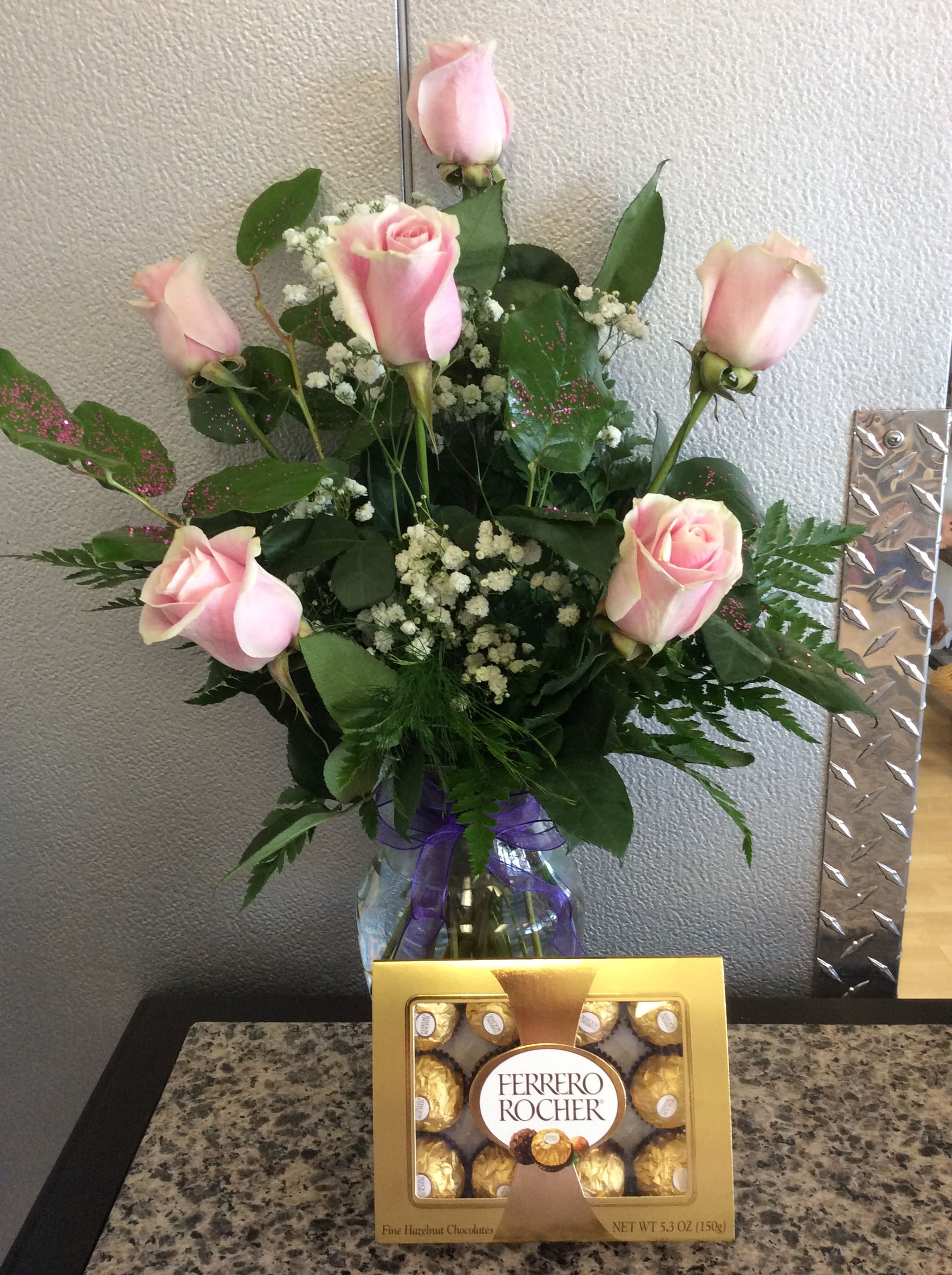 Half Dozen Pink Roses - 6 light pink roses in a glass vase with sparkly leaves. Chocolates included