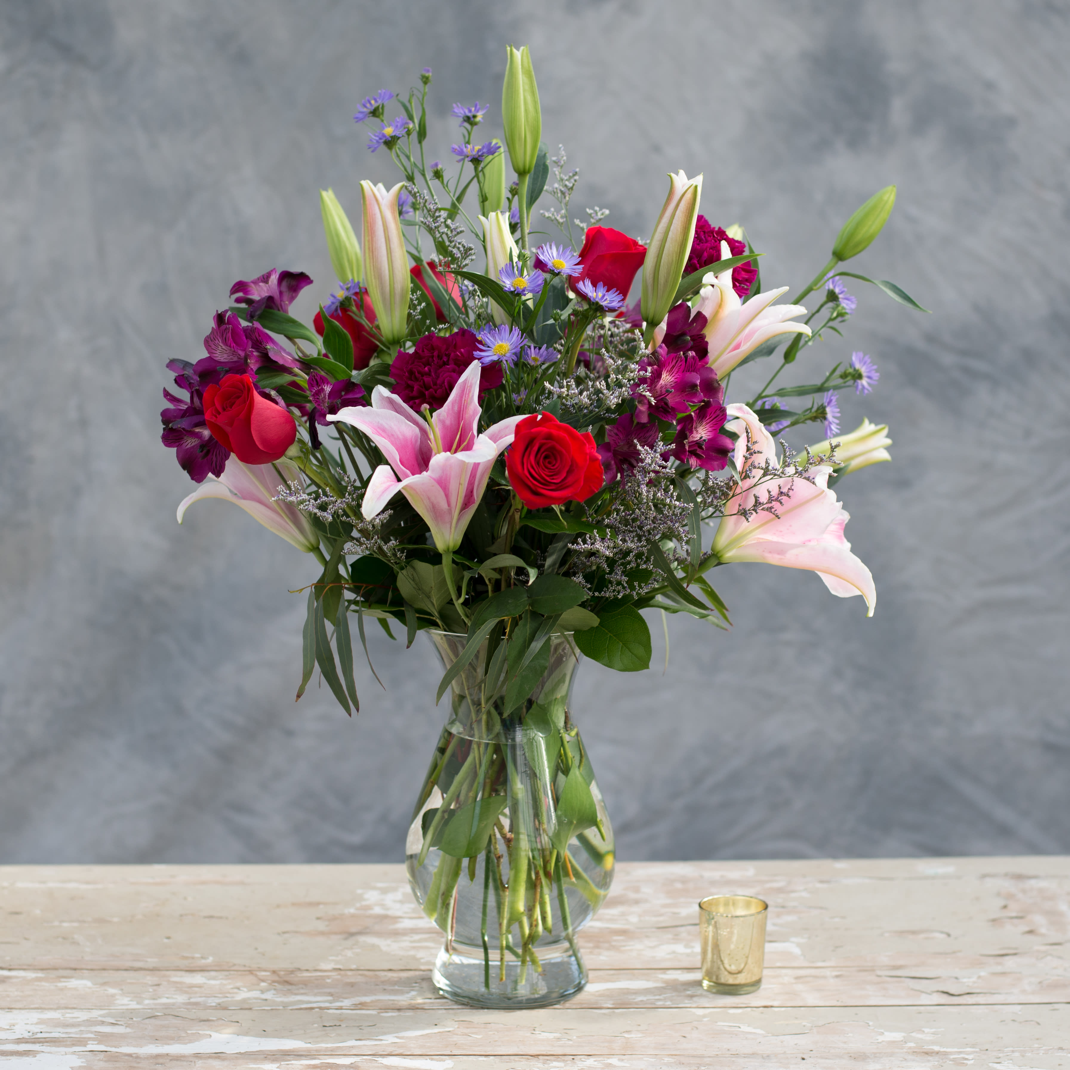 Say No More - What is left to say, when your special someone receives this classic glass vase, bursting with stargazer lilies, red roses and purple accents and a variety of greens?  Say No More! 