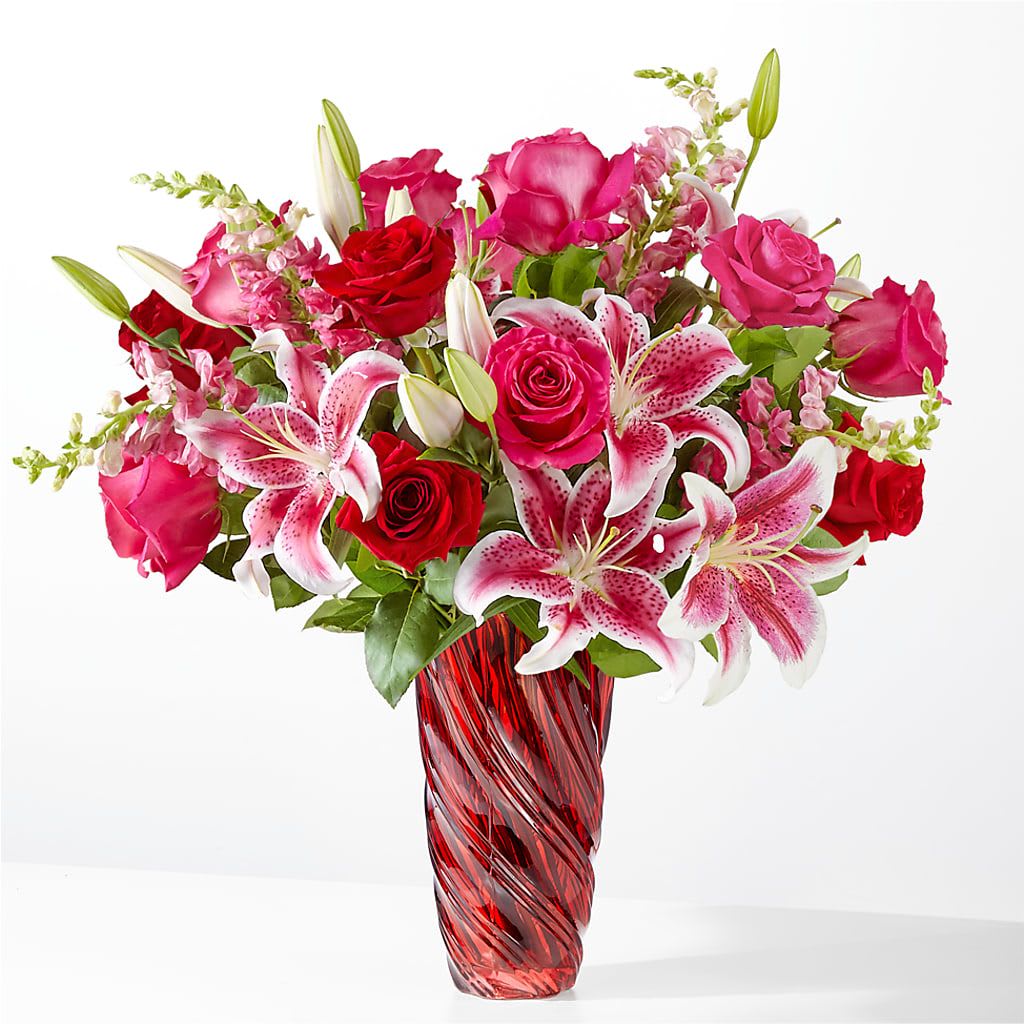 Always You Bouquet with Red Vase - A luxurious and decadent design of roses, lilies, and snapdragons that will fill their day with beauty and magic.  Approximately 25"H x 24"W.