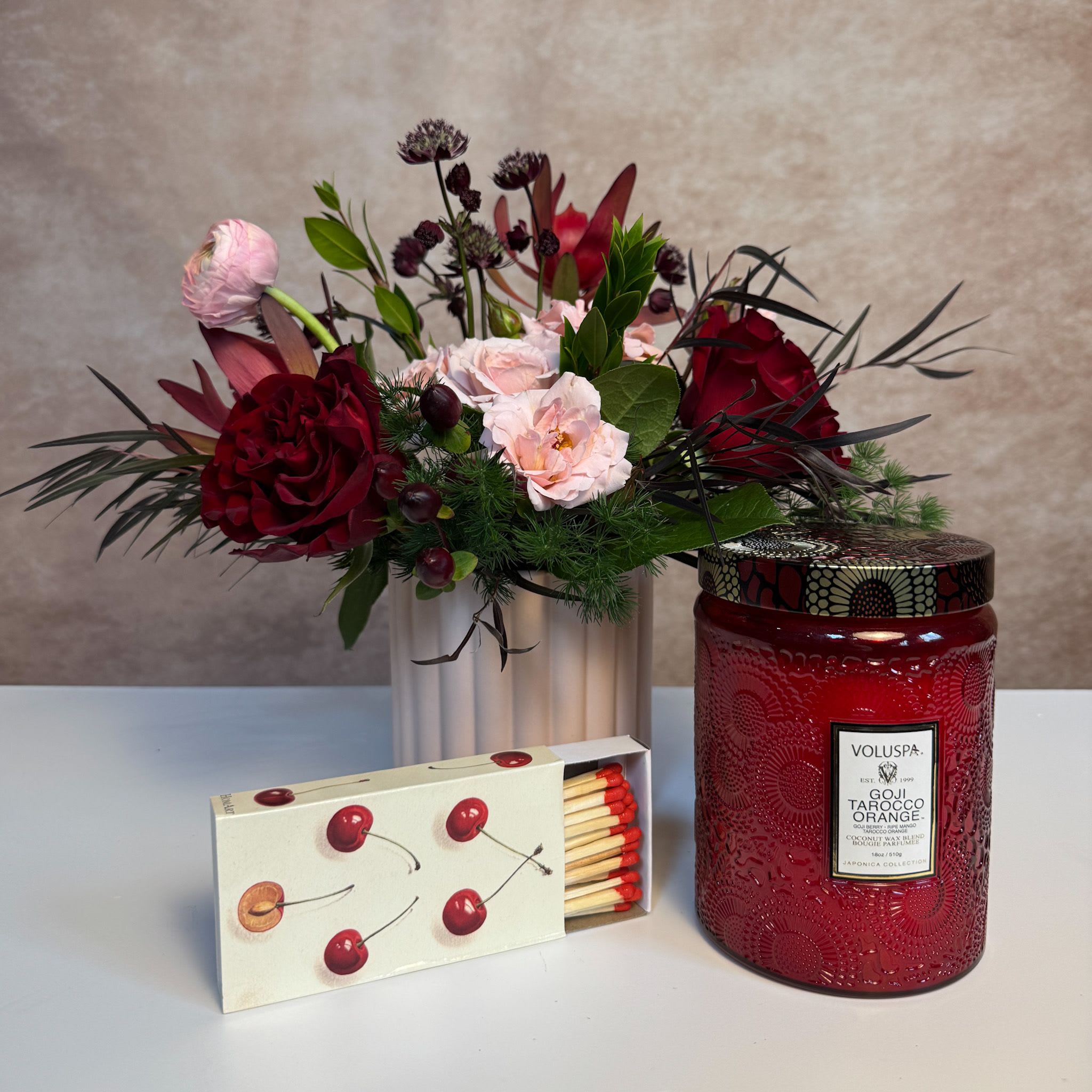 Be Mine Gift Set  - This set comes with a custom arrangement in a pink vessel, a candle, and a beautiful box of matches. Upgrade to Deluxe or Premium for additional blooms. Arrangement measures approximately 9" x 9"