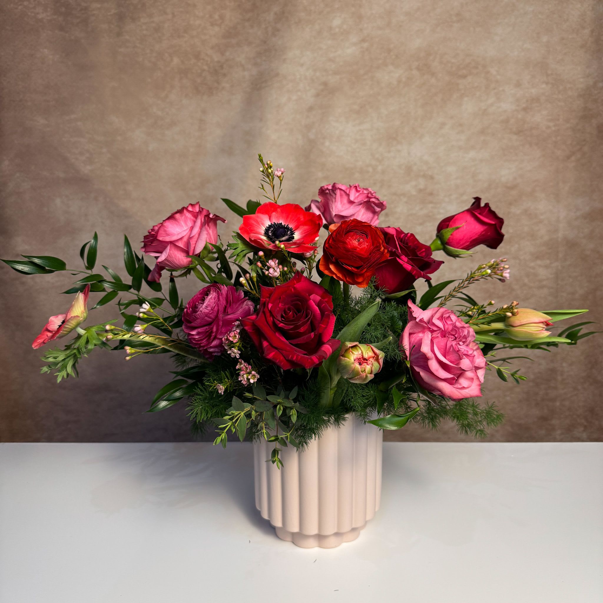 Queen of Hearts - Unique and bold stems set this arrangement apart from the traditional. Send this arrangement to anyone who appreciates bold color. Upgrade to deluxe and premium for additional luxe blooms.
