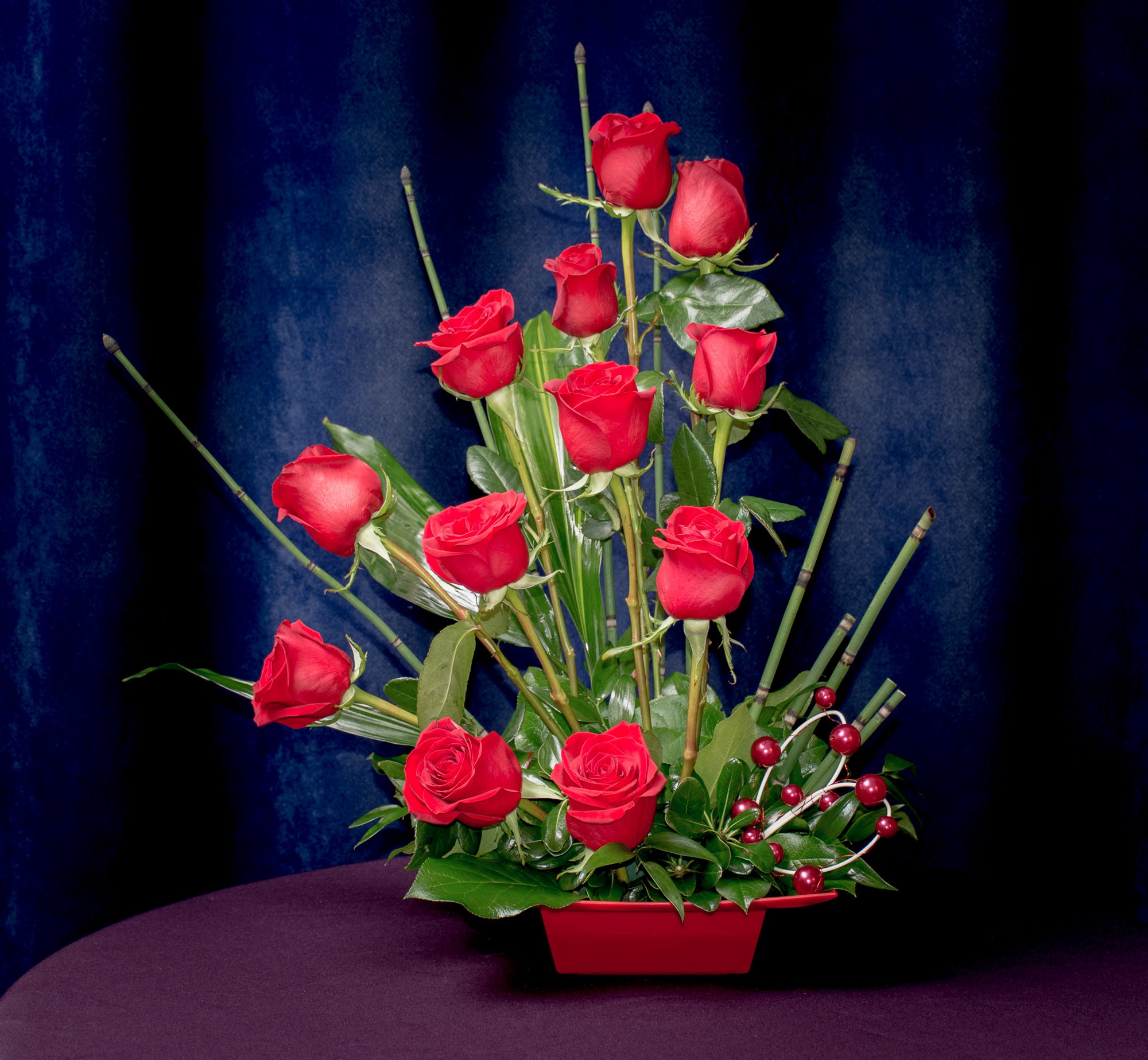 Radiance - Stylized arrangement of Red Roses.  Something out of the ordinary for that one of a kind look.  