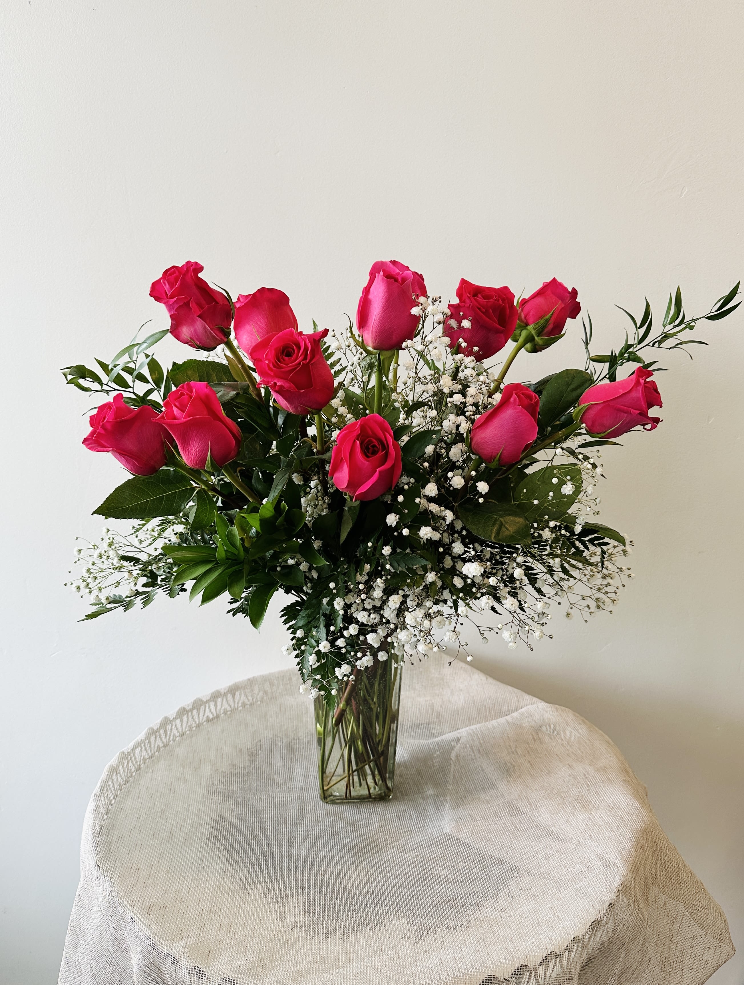 Dozen Hot Pink Roses - Dozen hot pink roses in a vase.   Standard: 12 roses Deluxe: 18 roses Premium: 24 roses