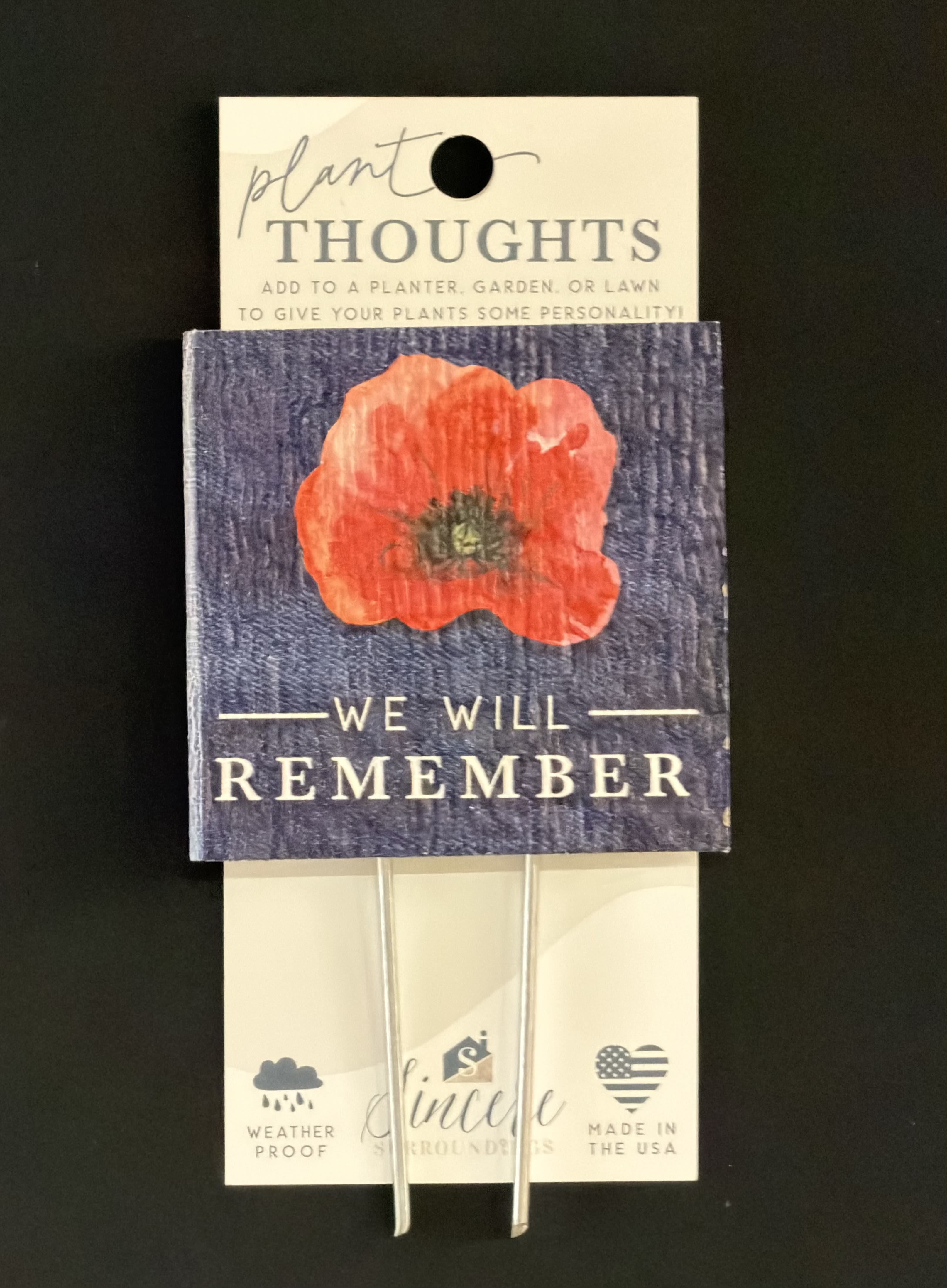 Plant Thoughts "We Remember Poppy" - Thoughtful sentiment and functionality come together with plant thoughts! Plant thoughts are the perfect way to send beautiful and thoughtful words to someone.  The recipient can then infuse their garden and flowers or plants with love and meaning. They also offer up the perfect touch for floral gifts. Proudly designed, manufactured and printed in the USA. Size: 4" x 5.75" x .5"  "We remember poppy" refers to the tradition of wearing artificial red poppies to commemorate military personnel who died in war, symbolizing sacrifice, bloodshed, and remembrance, inspired by the poem "In Flanders Fields" and used globally by veterans' groups for fundraising and honoring the fallen. The red poppy grew on battlefields, representing the lives lost, and is worn around Remembrance Day (Nov 11) or Memorial Day. 