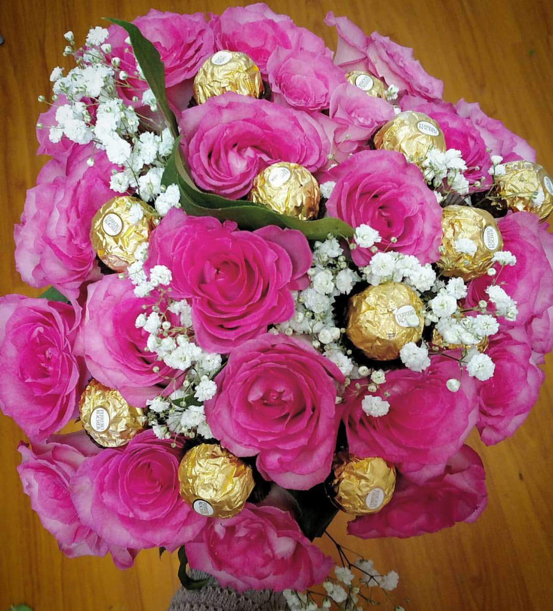 Pink Sweet As Can Be Rose Bouquet - Choose from 1 dozen pink roses to 2 dozen and they both come with 1 dozen Ferrero Rocher Chocolates that is wrapped in brown parchment paper with a pretty pink bow. 