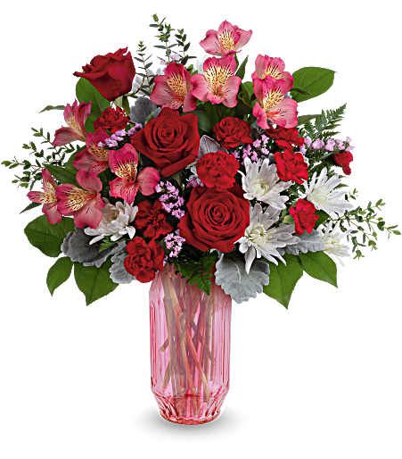 Gorgeous Gem Bouquet - Celebrate love's radiant hues in a stunning Valentine's Day mix of red and pink blooms in a shimmering faceted pink glass vase that sparkles with modern romance. Approximately 18 inches wide and 18 1/2 inches tall for the Standard size.