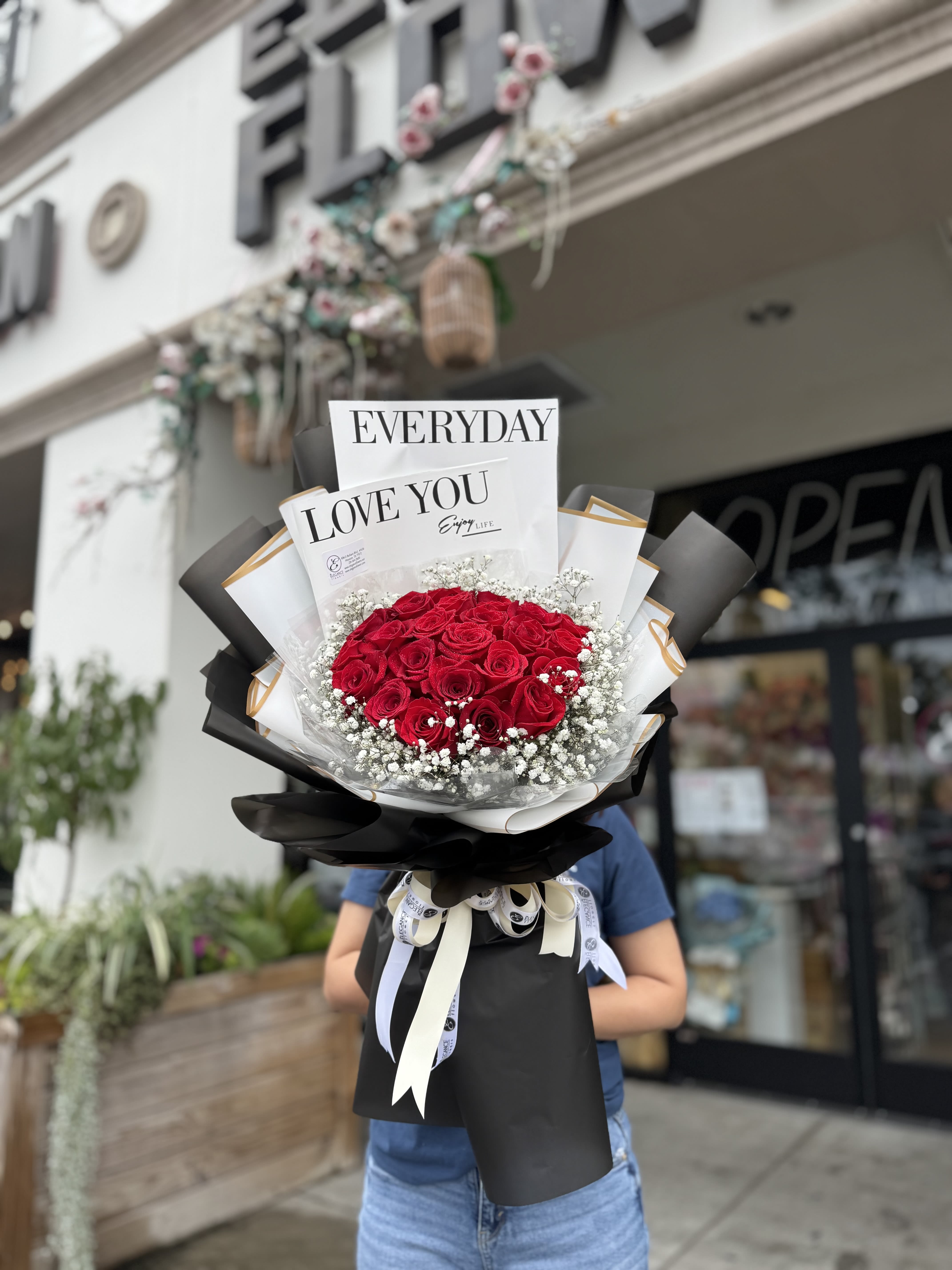 Wrapped Bouquet #21 - A wrapped bouquet of flowers is a beautifully arranged collection of blooms, carefully selected and elegantly wrapped in decorative paper or fabric. These bouquets often feature a mix of fresh, vibrant flowers, complemented by lush greenery, and are tied together with a ribbon or twine. Wrapped bouquets are perfect for any occasion, from expressing love and gratitude to celebrating special moments, offering a thoughtful and visually stunning gift.