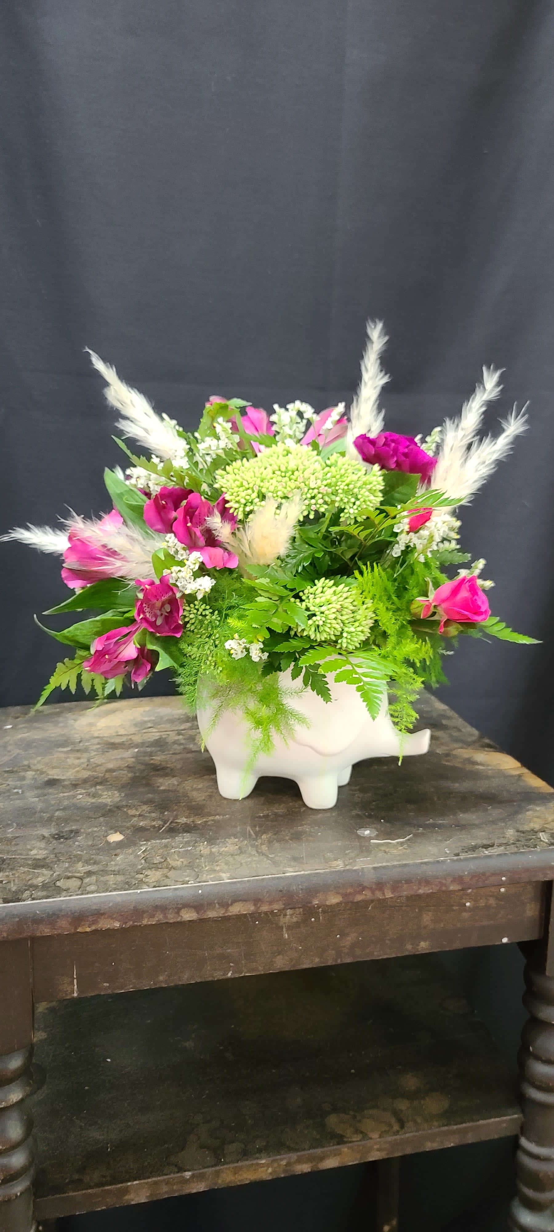 Ellie the Elephant - We are in love with this super adorable ceramic elephant. She comes in three different colors, grey, white, &amp; pink and is stuffed full of beautiful blooms. You can request specific flower colors in the special instructions section. Ellie is super cute on a desk, dresser or kitchen counter and she adds a touch of whimsy everywhere she goes.