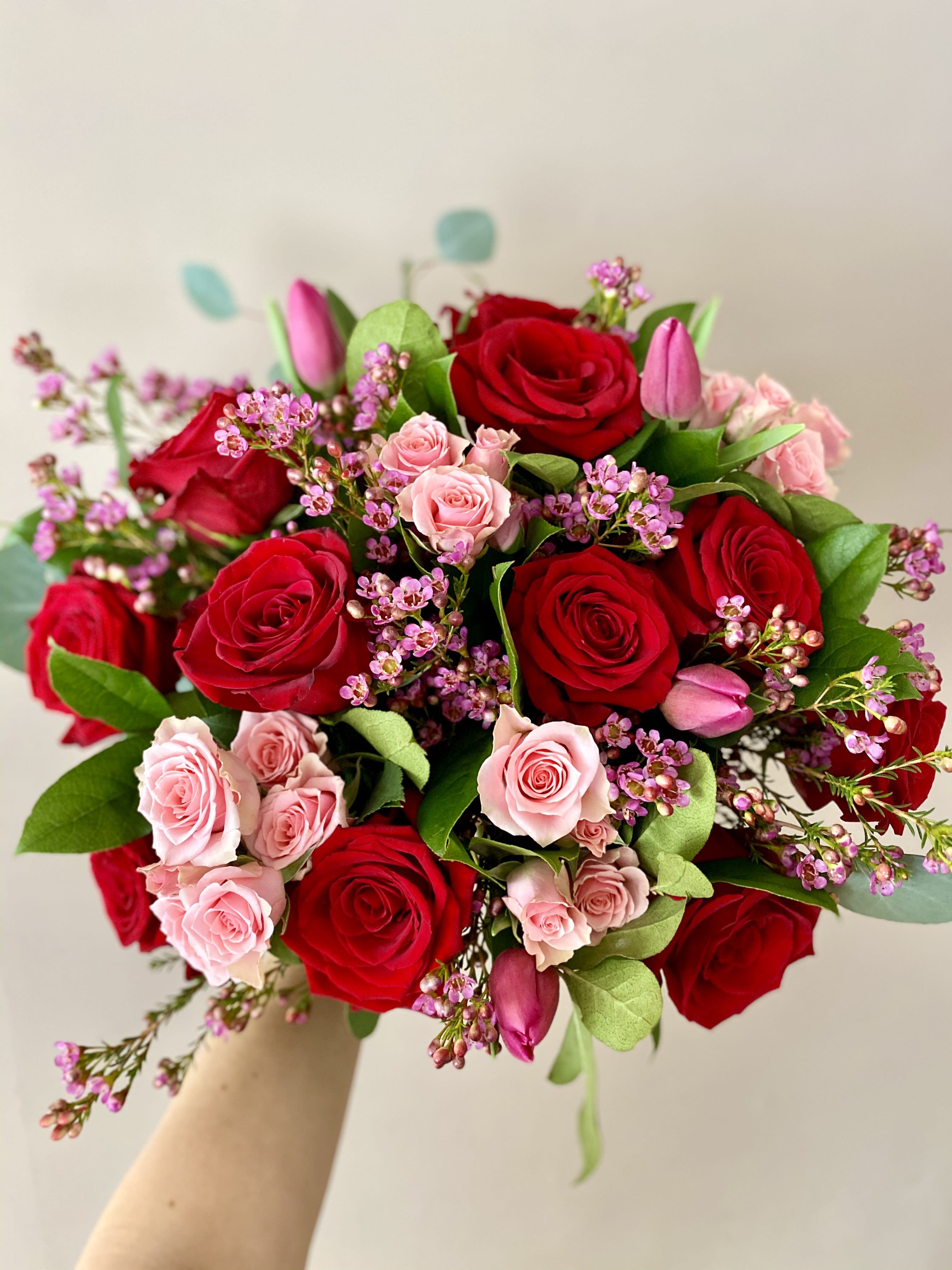 I Choose YOU! - And I'd choose YOU, in a hundred lifetimes, in a hundred worlds, in any version of reality, I'd find you and I'd choose you!   - The Chaos of Stars  This poem sums it all up! This hand-tied and nicely wrapped bouquet (NO VASE) will hug your loved one's heart! Say "I Choose YOU" with a dozen red roses arranged with spray roses (color may very based on availability) and tulips (color may very) with a mix of greens and filler flowers.  You can't go wrong with this bouquet for Valentine's Day, or to wish your special one a Happy Birthday or to celebrate your Anniversary!  Bouquet will come nicely wrapped for that extra wow effect!