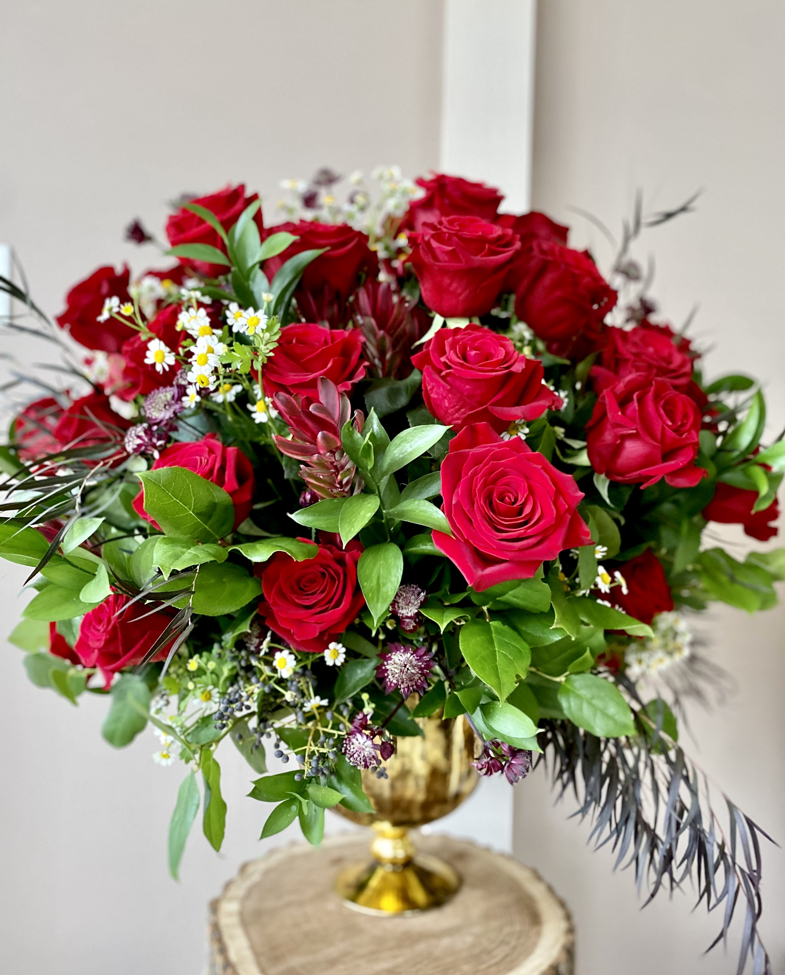 I Love You x 50! - 50 red roses!!! It's one-of-a king arrangement! Huge, impressive, bold... just WOW! Ah, you know she is worthy of all the blooms on this earth! Let us help you to show your love with 50 high quality amazing red roses, romantically arranged in a unique vase, along with a greenery and textural elements. 