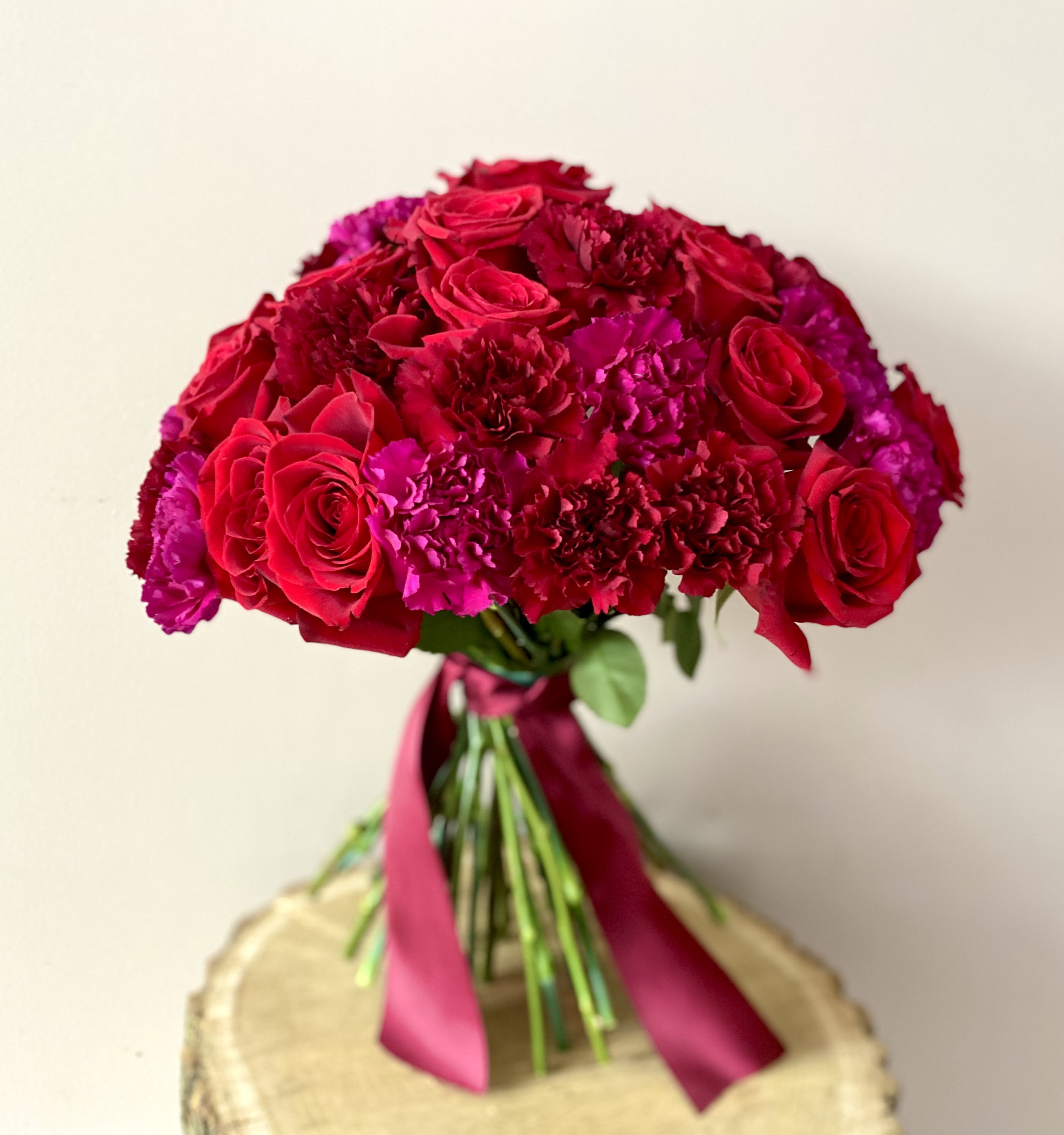 I have found the ONE whom my Soul loves - Lush, elegant, and unique bouquet will definitely make Her smile!  The red rose began its well known symbolic history by being the favorite flower of Venus, the Roman goddess of love and continues to be the iconic representation of expressing affection and intensity of romantic love. Red carnation say: “my heart aches for you”, and symbolizes admiration and affection.  18 red roses and 2 dozen carnations (mix of two tones, color will vary based on availability) will make her hug you closer! You can't go wrong with this beautiful bouquet!   Flowers will come nicely wrapped for that extra WOW effect! 