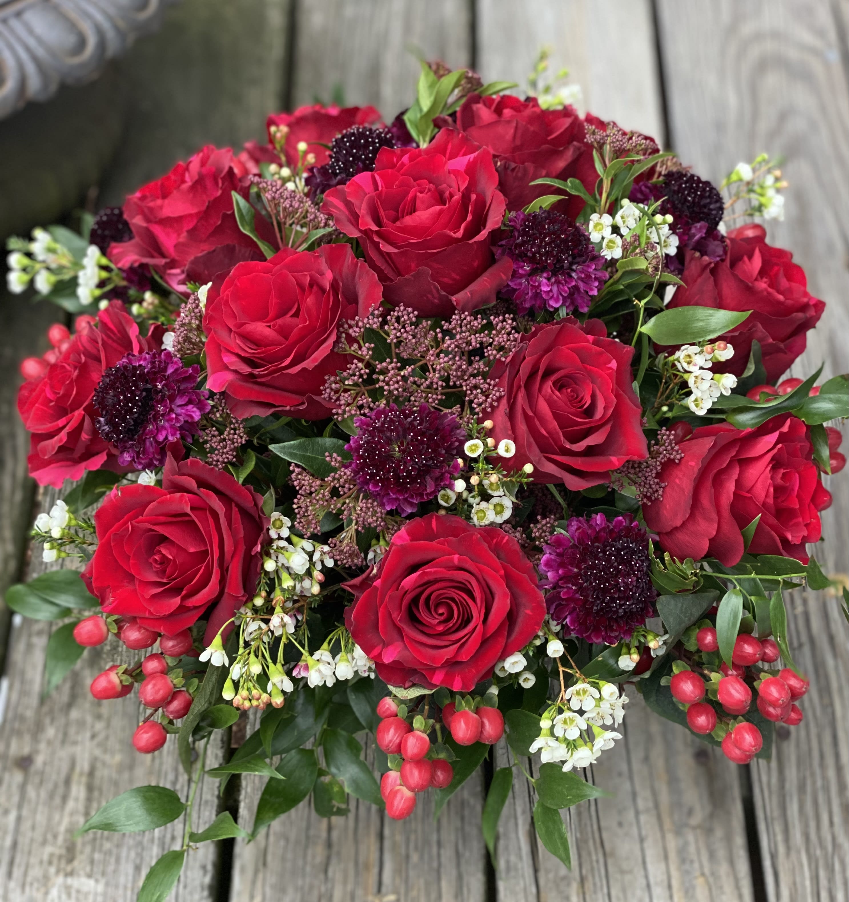 Red Roses - Red roses, accented with scabiosa, berries &amp; beautiful greens, with leaf wrapped, low glass vase.