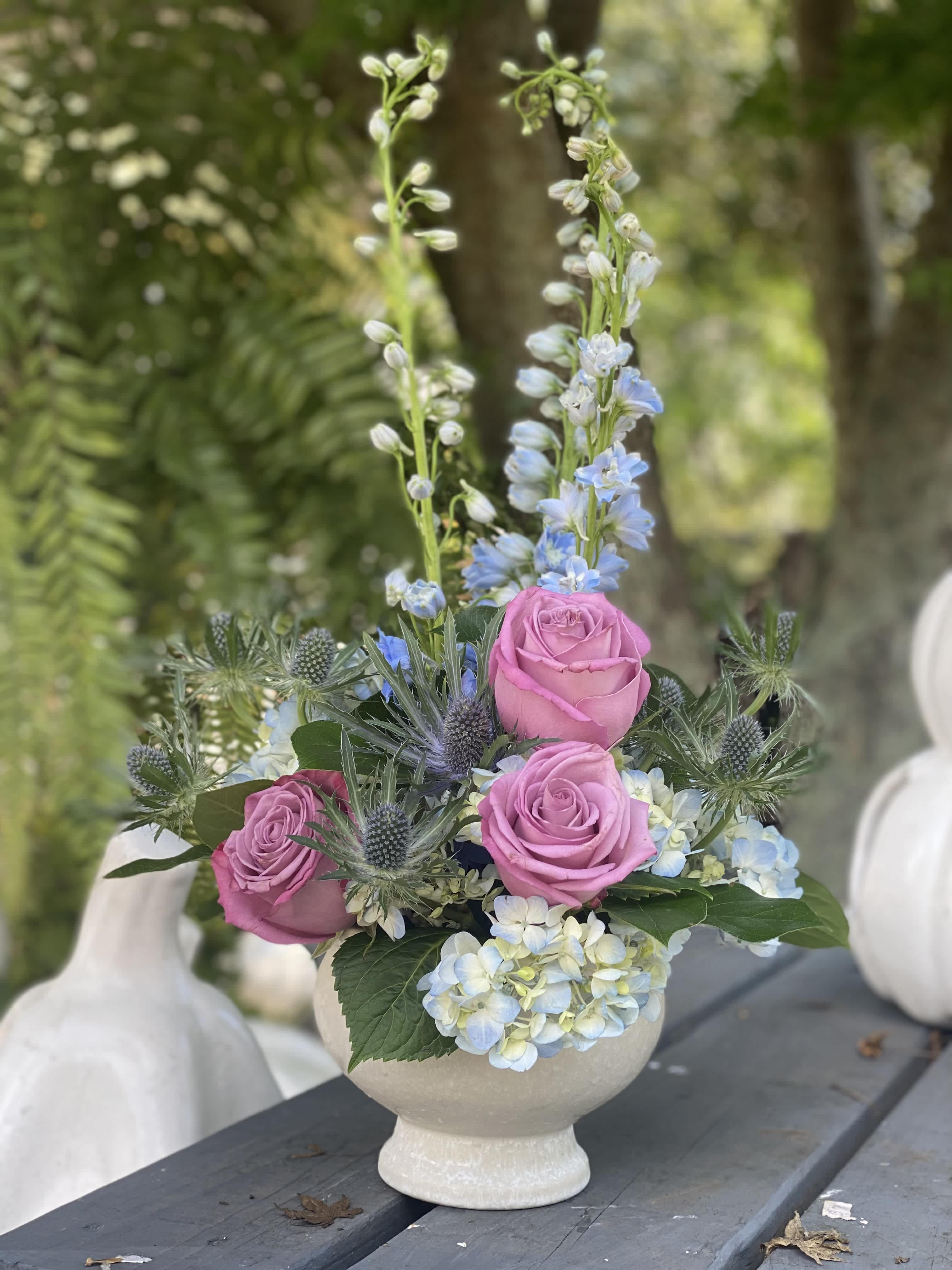 Dressed for the Occasion - White compote (pedestal bowl) filled seasonal flowers like Delphinium or stock, hydrangea, spray roses or thistle, lavender or pink roses. Truly an all occasion elevated statement piece that would work well on an entry table, or small dining table as a centerpiece. It is also small enough to be placed at the bedside with a message for wellness.  Deluxe dimensions: 13" diameter, 22" total height
