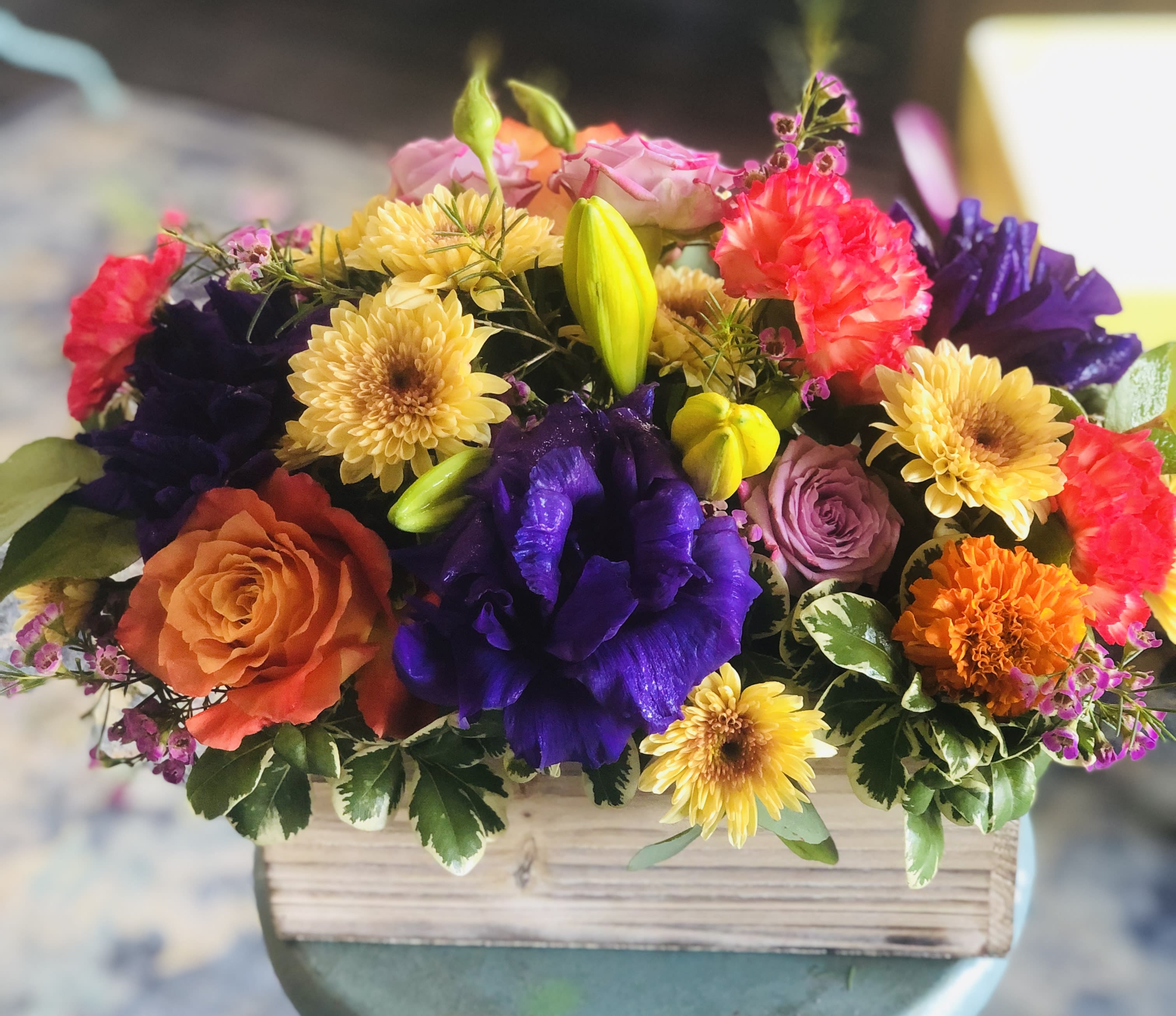 Bejeweled - Keep things fun with this jewel toned flower box!  Roses, Lisianthus, Jelly Carnations in a wooden garden box give this arrangement its bright colors and textures to create a beautiful centerpiece or gift.    **Please let us know if you have specific flowers in mind or colors. We can mix it up depending on inventory.**