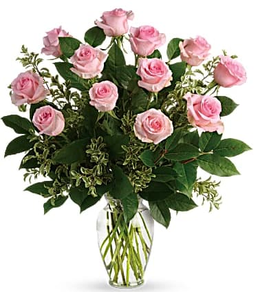 Say Something Sweet Bouquet - Soft as a whisper, this pretty bouquet of a dozen sweet pink roses and deep greens are simply divine for any occasion! 12 pink roses are arranged with pitta negra and lemon leaf. Delivered in a clear glass vase. Orientation: All-Around