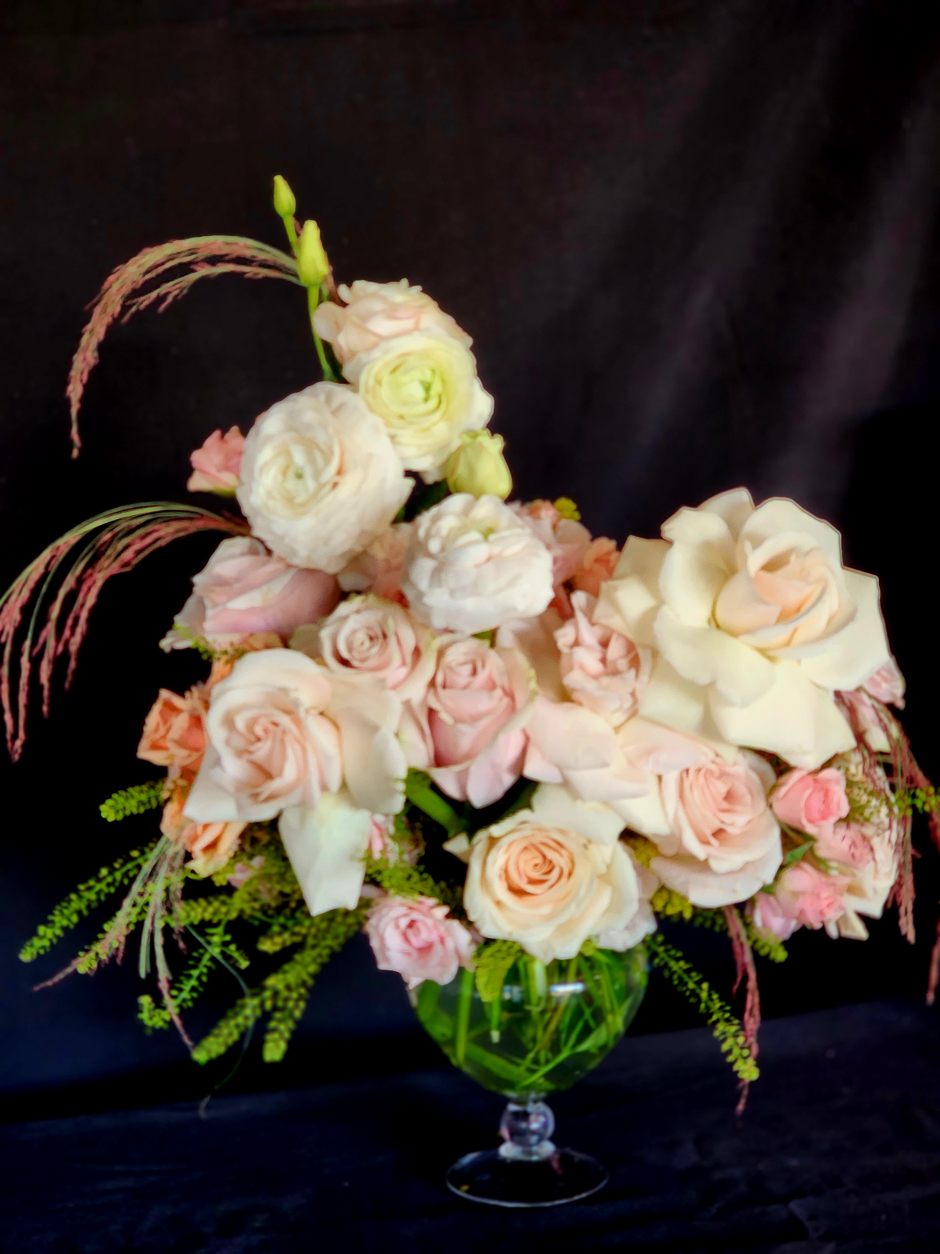 La Princesa - For the Princess in your life. Soft Pink Roses, Spray Roses, Ranunculus and Lisianthus. Deluxe and Premium might contain Garden Roses and Peonies.