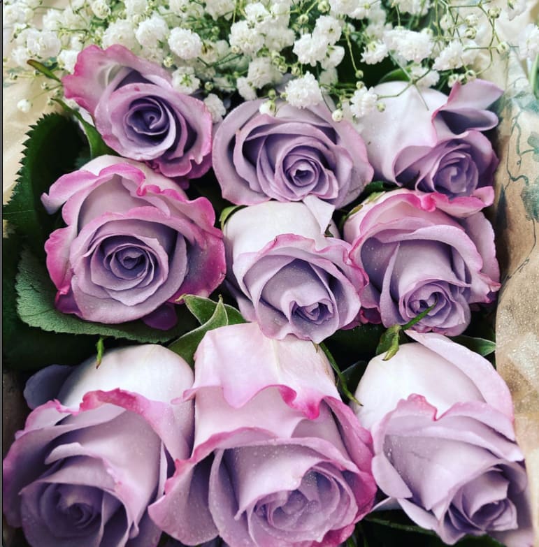 12 long stem Lavender Roses in a box - 12 long stem lavender roes in a box with greenery elegantly set. Upgrade provides 24 stems.