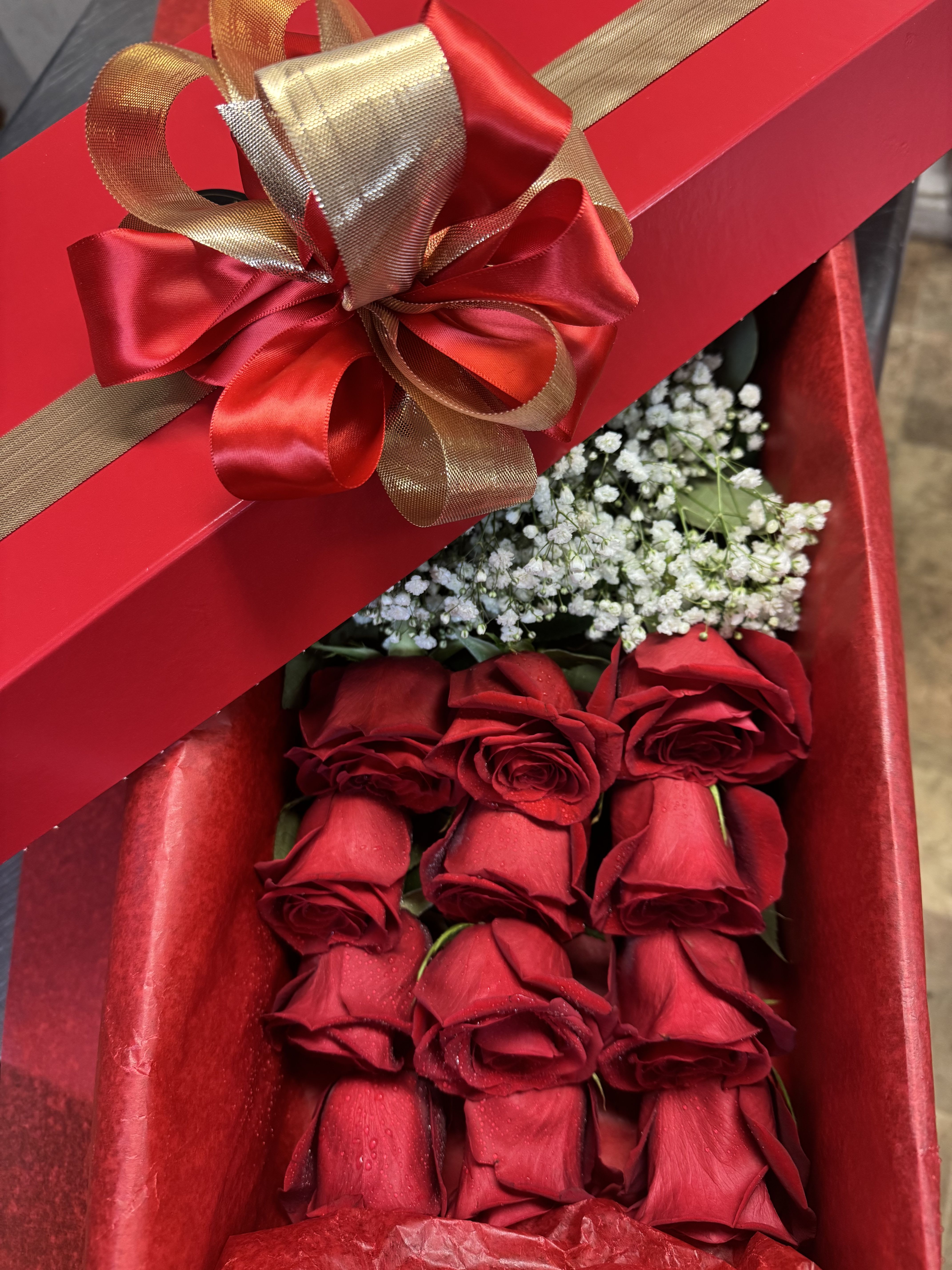 12 Long stem Red Rose Box  - Gorgeous long stem red roses for your love, simply the best! Prepare with care and protected by our sophisticated box-perfect to keep your flowers protected from the weather and for easy transportation-, nestled in tissue paper with little water tubes to ensure freshness (remove tubes upon arrival, re-cut stems and place in in water with solution provided in the package). An elegant bow finish the box with class. Upgrades provide extra dozen stems. Box color is subject to change.