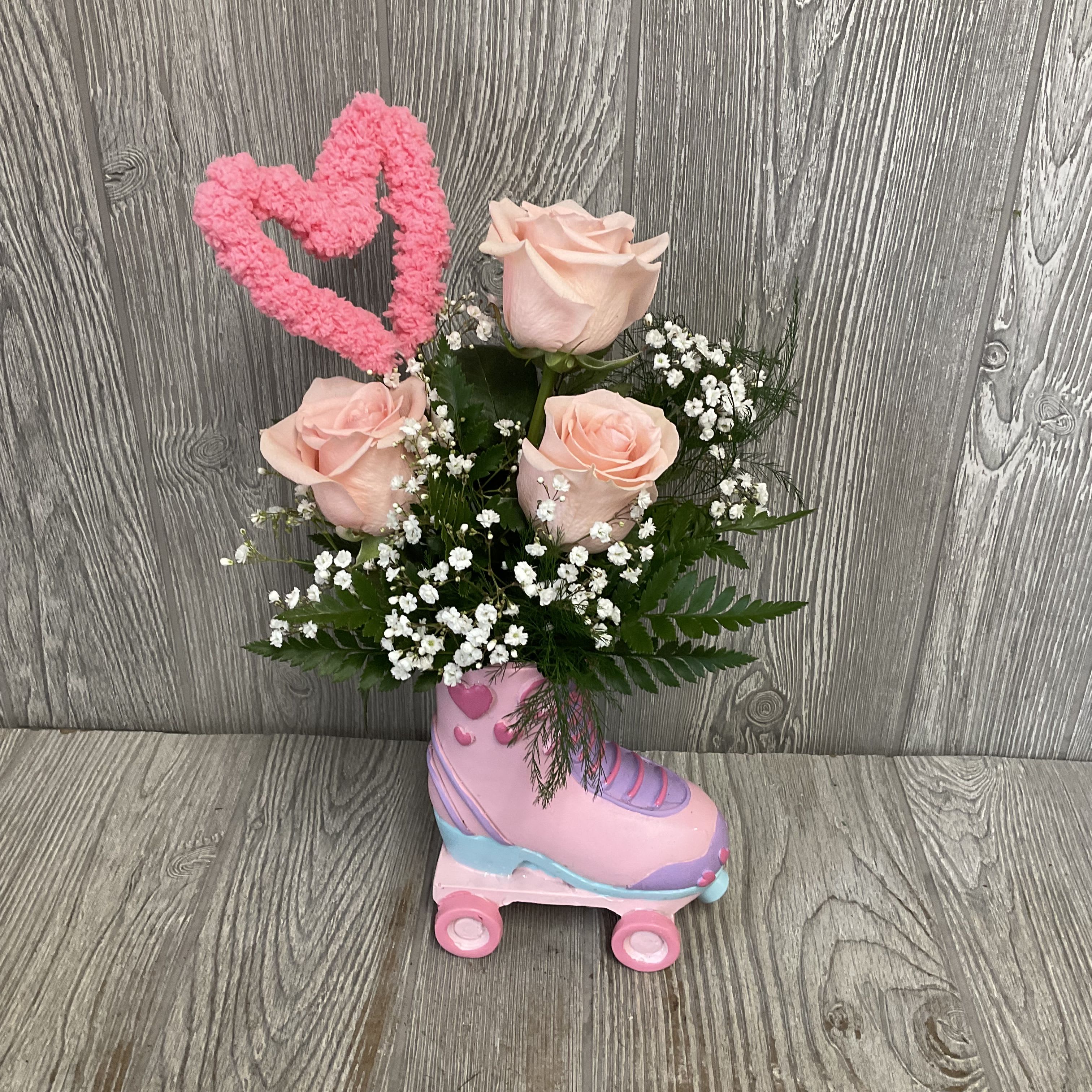 Wheel You Be Mine? - Beautiful light pink roses arranged in a keepsake ceramic roller skate container. Colors and flowers may vary. 