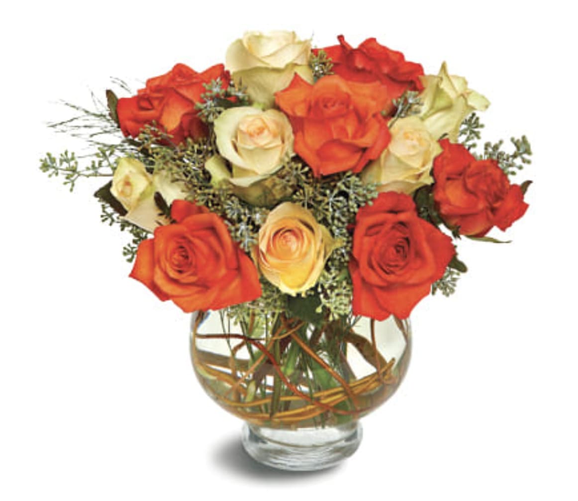 Harvest Moon Roses - The harvest moon is round and orange-gold, and this rounded display of orange and pale yellow roses, accented with seeded eucalyptus and presented in a vase decorated with vines, is reminiscent of the prettiest full moon. A charming selection.