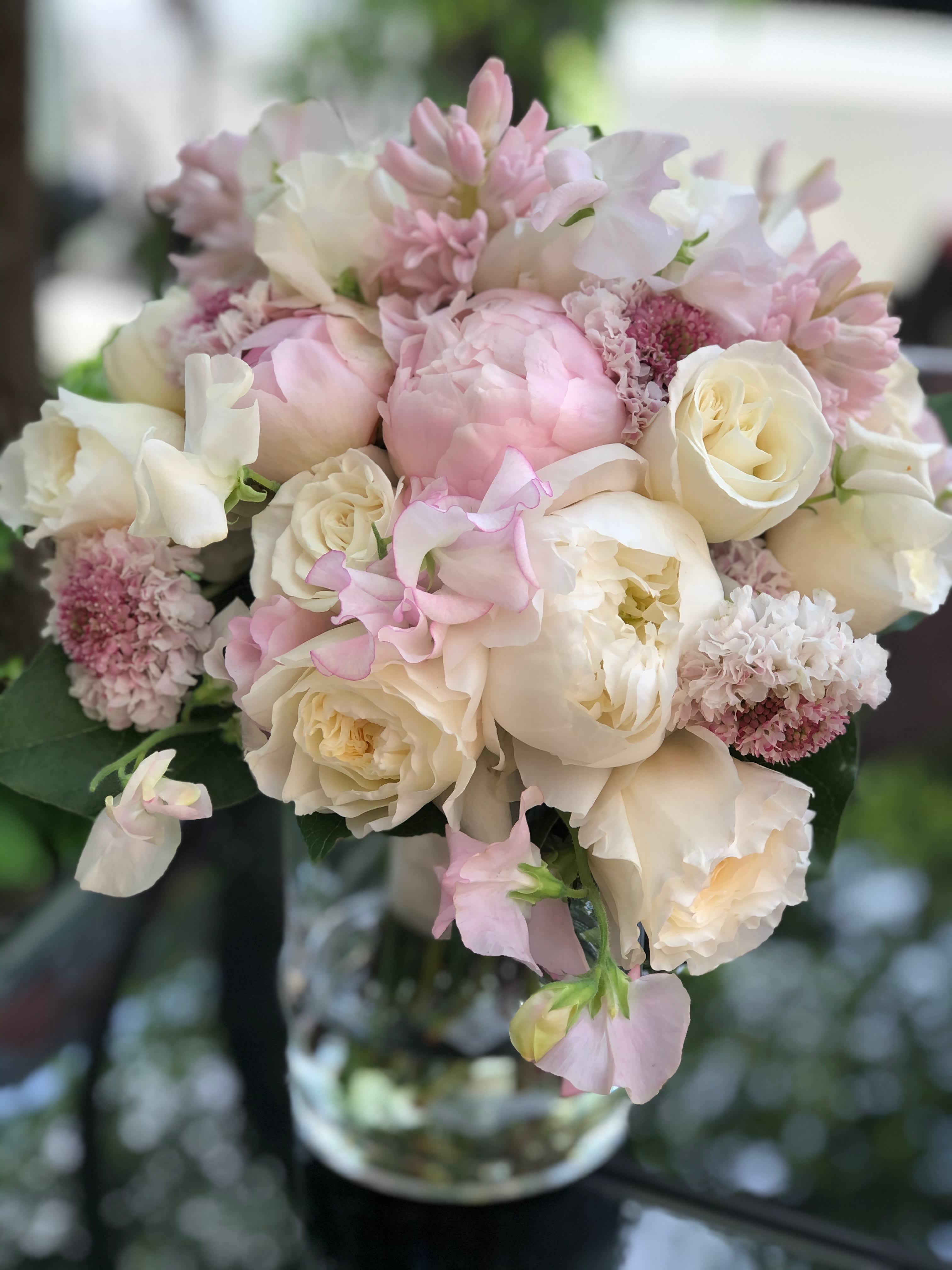 Pastel whites and pinks - A beautiful collection of roses, peonies and few other romantic blossoms in our fresh pastel collection. 