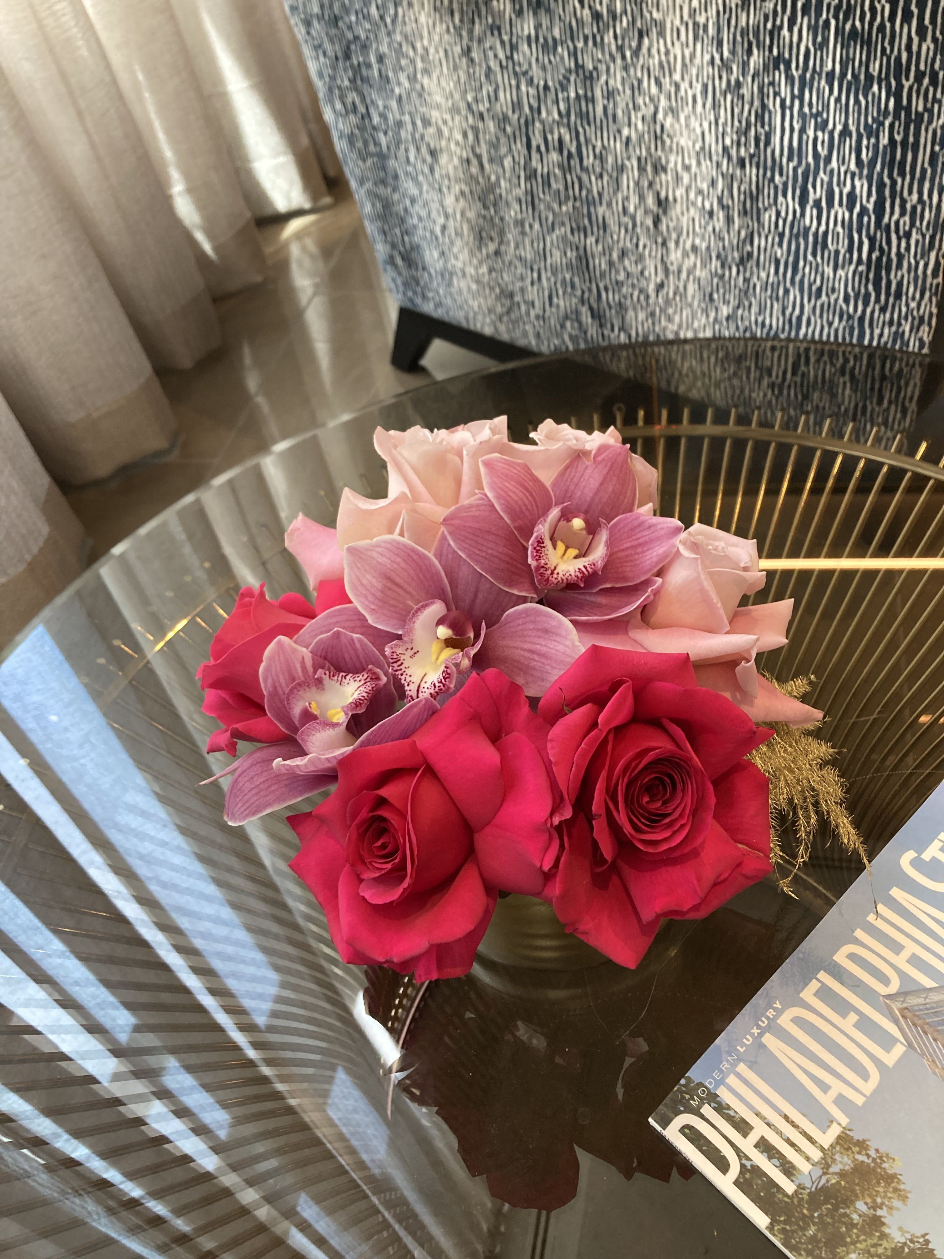 Thinking of you: roses and orchids - Celebrate friendship with gorgeous pink and hot pink roses complemented by lasting and elegant cymbidium orchids. Beginning size is small and delicate, upgrade for larger size.