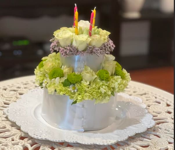 Many Happy Returns - Sweet as a birthday cake, this creative, bouquet of spray roses and hydrangeas, topped with birthday candles, is sure to delight them on their special day! This cake-inspired floral arrangement is not intended for consumption.