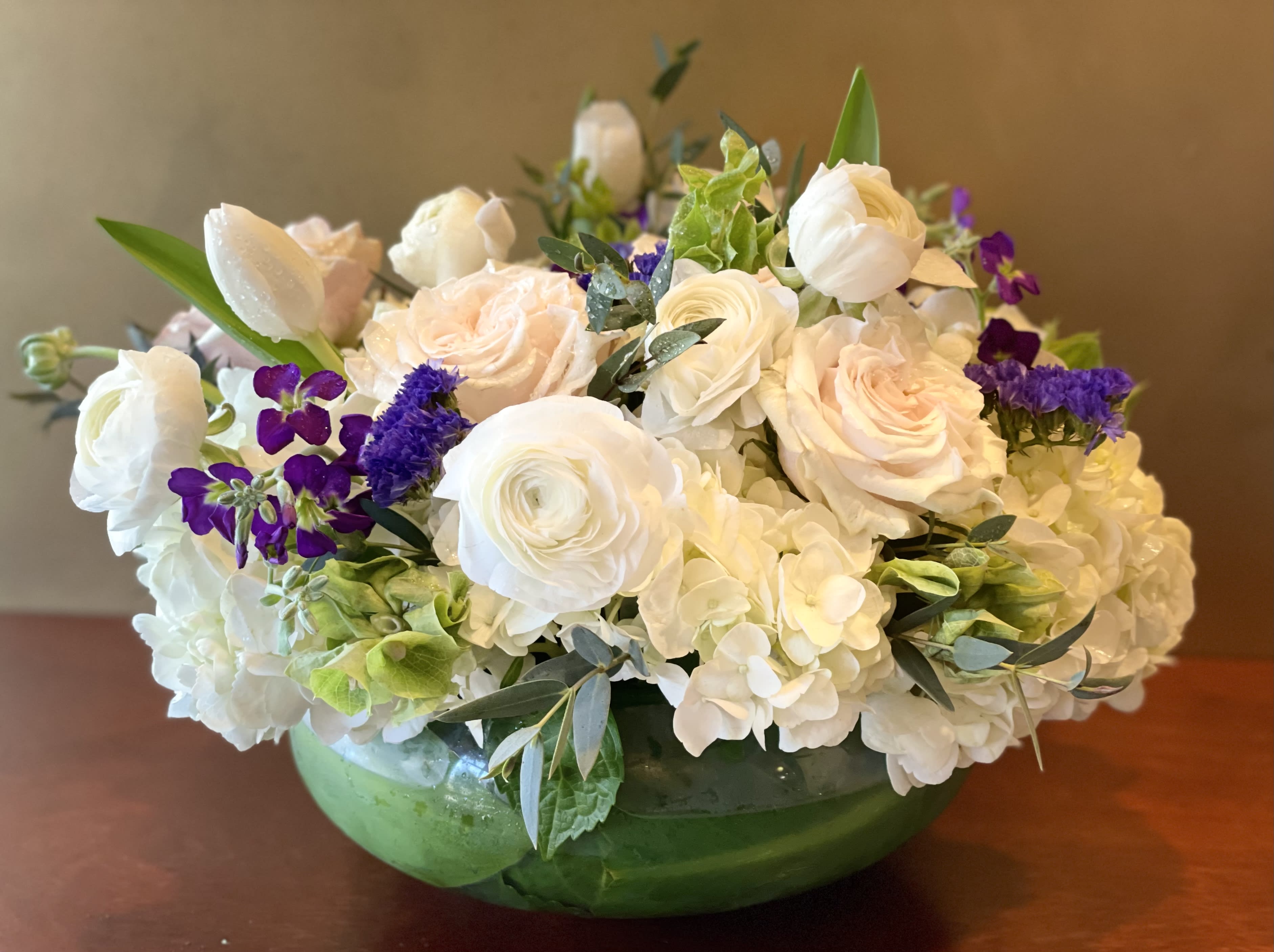 Oh La la! - Charming and easy on the eyes, with beautiful white tones, this bouquet brings a room to life with it's artful appearance. White roses surrounded by white tulips, white hydrangeas and greenery.