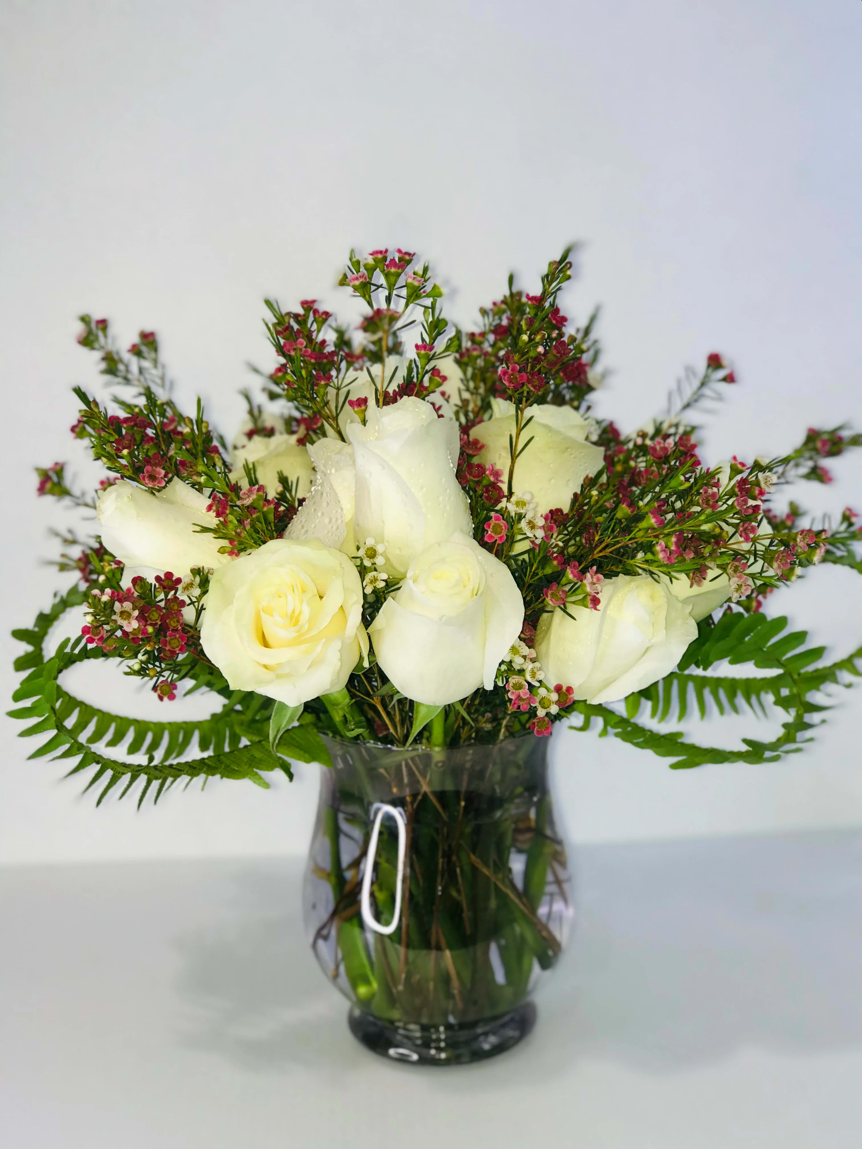 Pearly Perfection - This beautiful arrangement is both freshly curated and elegant, with a majority of white fragrant flowers and hint of color to compliment the overall appearance, and very tasteful greens folded in to better project the arrangement as a whole.