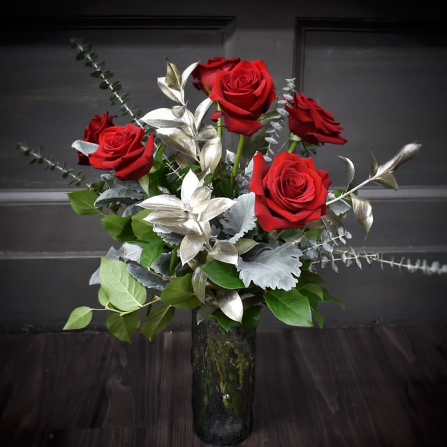 Platinum Love - This striking 6 red rose arrangement is the epitome of romance and elegance. Each rose, handpicked for its deep, velvety petals, stands as a symbol of love and passion. Arranged with care in a timeless, classic vase, this bouquet makes a bold yet graceful statement.