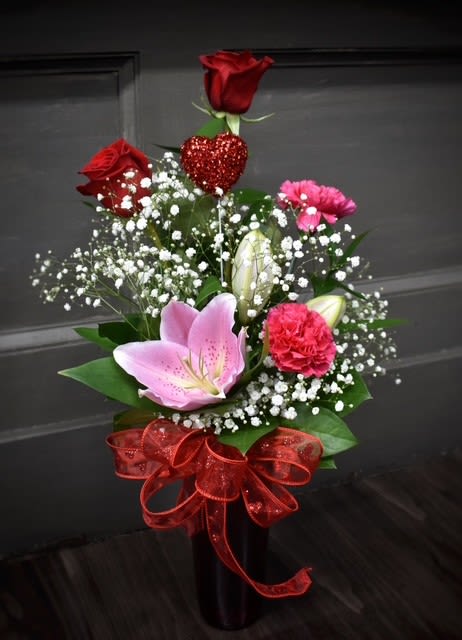 Simple Love- Available for local St Cloud, MN delivery only - A tried and true favorite of classic Roses and Stargazer lilies with carnations and babies breath arranged in a tall clear glass vase sure to make any valentine smile.  