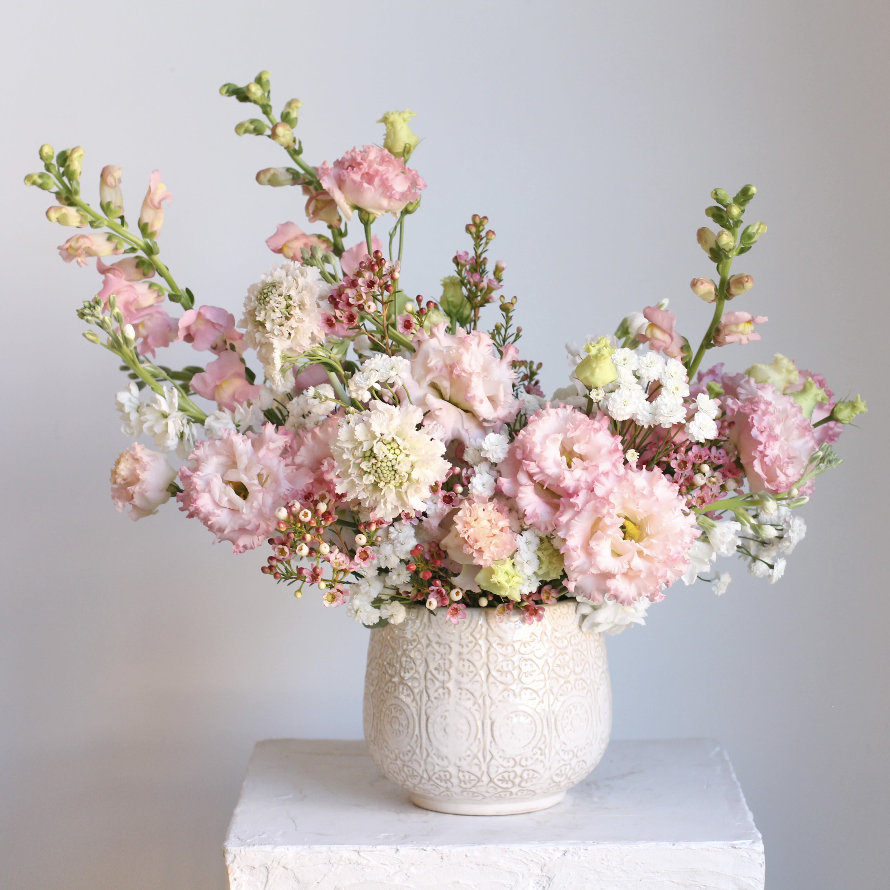 Deluxe Blush Arrangement - Brighten someone’s day with our Blush Blooms arrangement—a celebration of all things pink! The Standard Blush Blooms comes in a sleek, clear vase, showcasing the fresh beauty of every stem. Upgrade to the Deluxe Blush Blooms for an even more luxurious display in a gorgeous, large pink fluted vase that adds a sophisticated and unique touch to any space. Whether it’s for a birthday, anniversary, or “just because,” this arrangement is sure to leave a lasting impression and a BIG smile!  Delivery Policy: At Middlemist, we aim to make every delivery seamless and delightful. It is the sender’s responsibility to ensure the recipient is available to accept delivery between 3–5pm on the scheduled date and that the delivery address is accurate. We will send a text notification to the recipient on the day of delivery. If no one is available to receive the order, it will be returned to the shop and may be picked up or redelivered for an additional delivery fee. If a recipient requests the order be left unattended, we cannot guarantee the condition of the flowers or plants, and no refunds will be issued once an order is left outside.