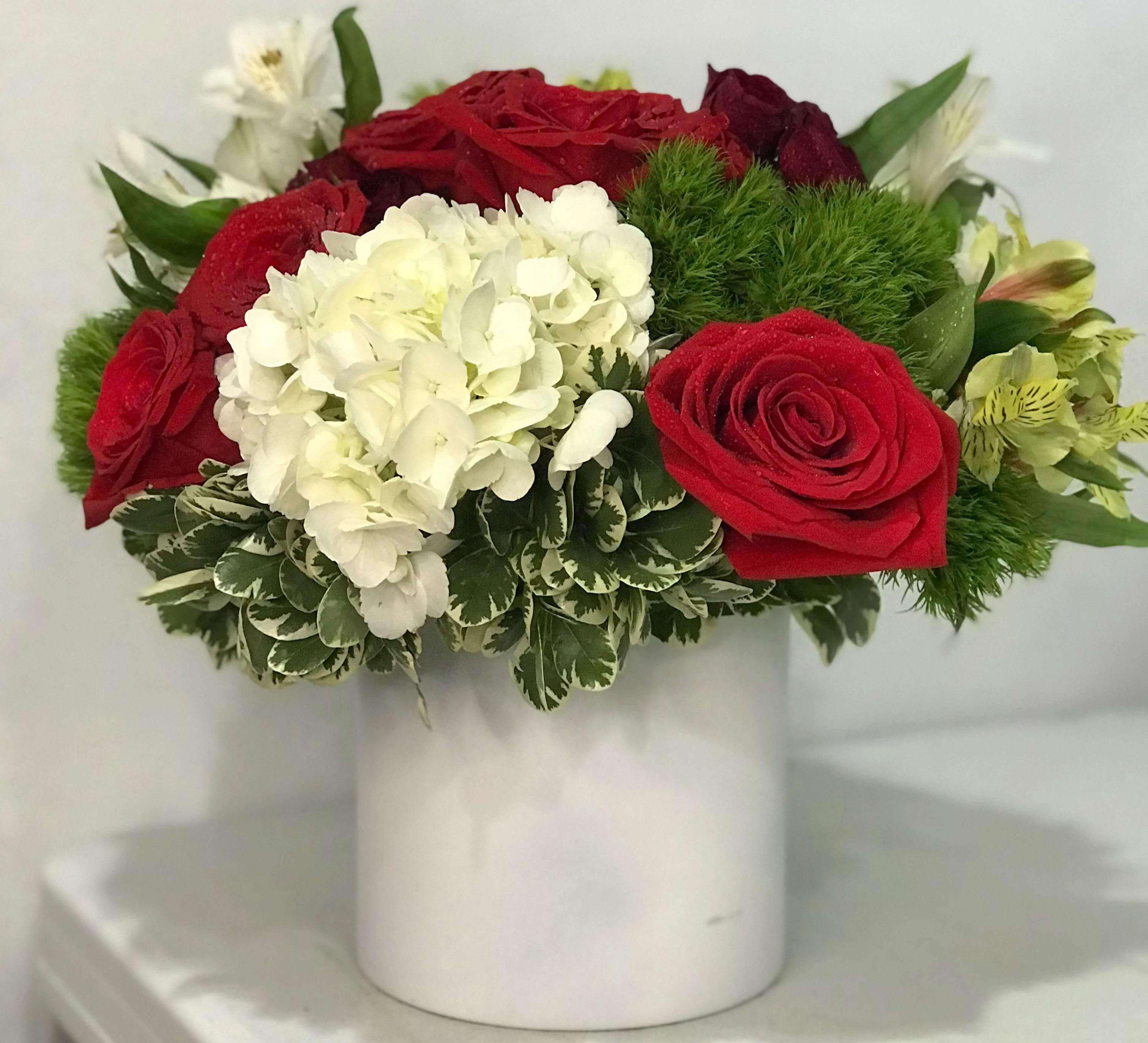 You're My Happiness - Colorful display of reds, white, and yellows. Sure to brighten anyone's day!  Please note: We use flowers that are available at that given time. The look and the freshness of the flowers are always the most important, therefore the arrangement may vary. We may notify you be email for any substitutions may be made based on best product available.