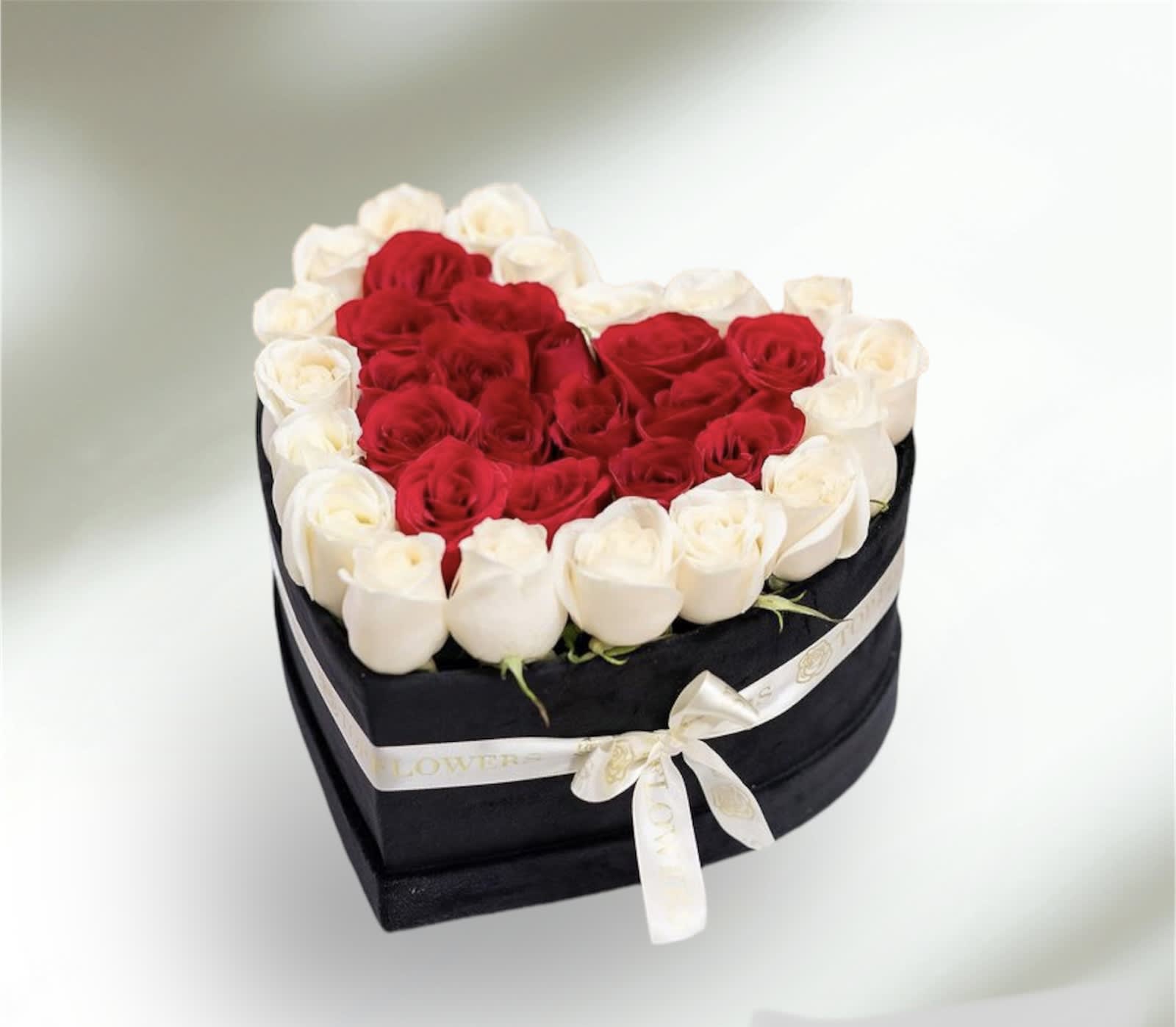 Hearts Delight Box Arrangement  - A sweetly romantic birthday present or heartfelt gift for a friend, this delightful arrangement pampers her with red and white roses - not to mention the modern heart shape box she'll use again and again!