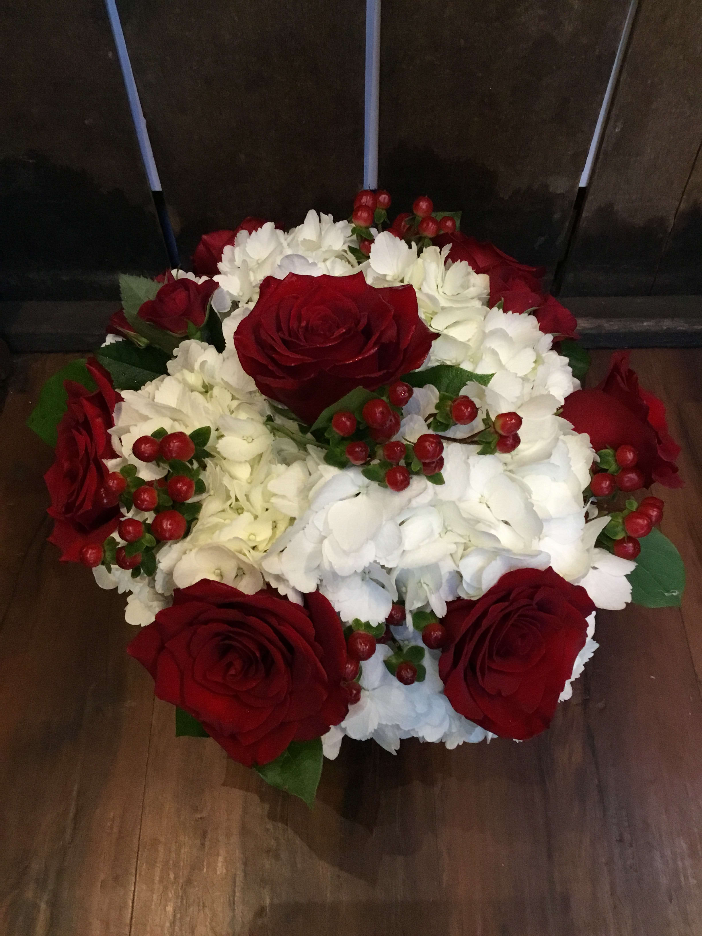 Roses and Hydrangea  - The perfect medium sized centerpiece to say “be mine” to your special someone. This arrangement is a combination of hydrangea, roses, spray roses and berries with a touch of greens.