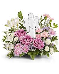 Teleflora's Heavens Arms Bouquet  - The In Heaven's Arms Bouquet gracefully combines pink or. lavender roses, pastel blooms, and delicate white accents surrounding a radiant crystal angel keepsake-a beautiful way to express peace, love, and remembrance. by huckleberry and leatherleaf fern. Includes a crystal angel keepsake figurine.  Orientation : One-Sided