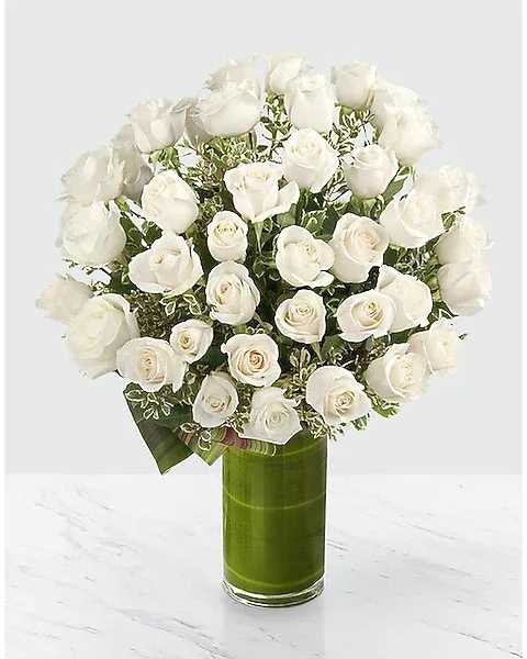Luxury pristine white Rose Bouquet - This stunning bouquet features 48 white roses, carefully arranged with greenery .The pristine white roses convey purity, peace, and respect, making this arrangement a perfect choice for expressing your heartfelt emotions..White roses are a symbol of new beginnings, purity, and serenity. This arrangement is ideal for commemorating important milestones, offering sympathy, or simply expressing admiration and respect