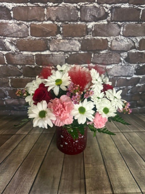 My Forever Valentine - A cute red tin cylinder with heart cutouts filled with daisies, roses and carnations!  Perfect for your Valentine. Approx.  14" W x 14" H