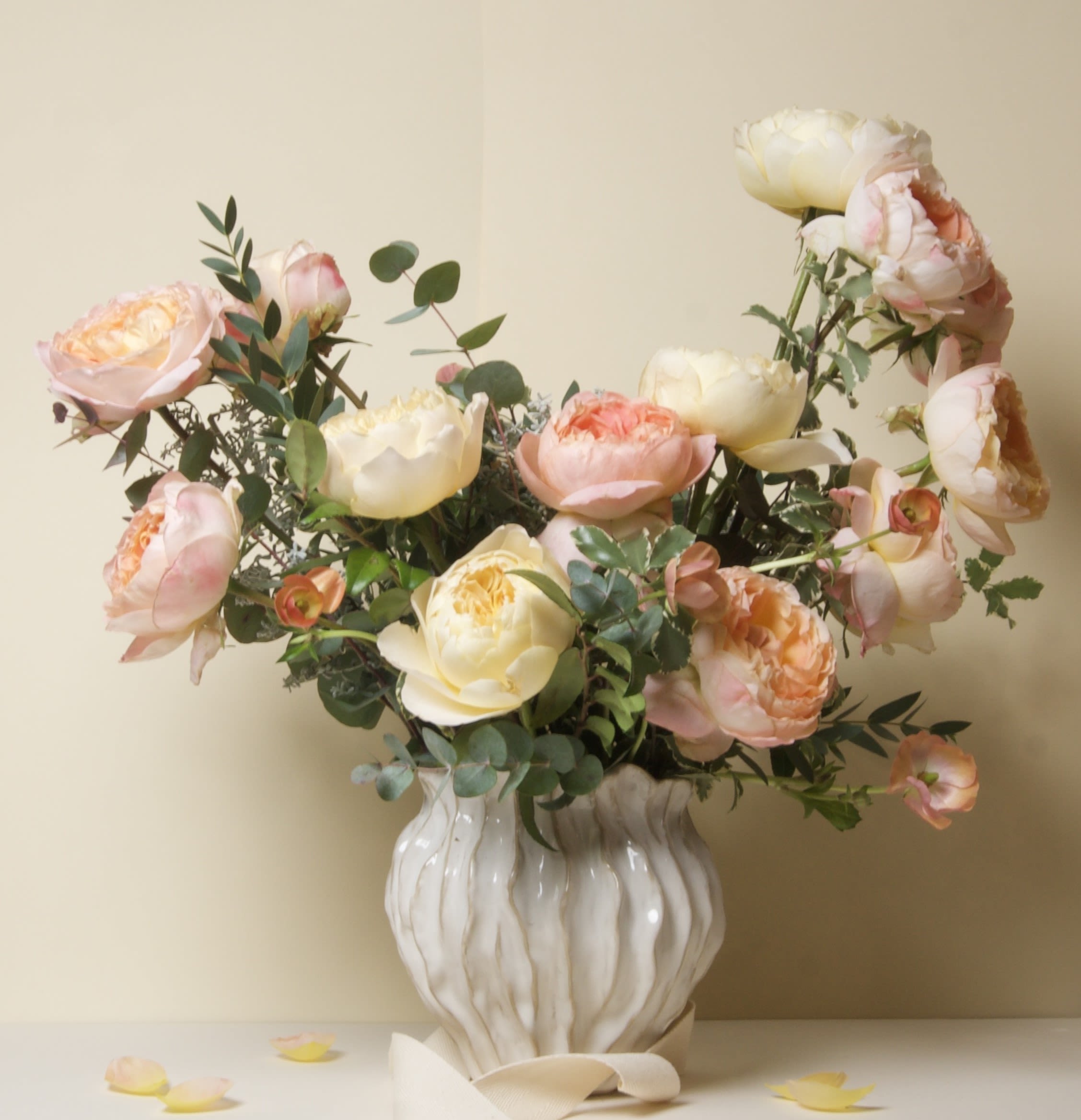 Mulberry - 88 - This stunning arrangement features lush garden roses in soft peach and cream tones, artfully arranged with seasonal flowers and fresh greenery. Each bloom is full and expressive, creating a graceful, garden-inspired design with natural movement and warmth.  Garden roses are beloved for their layered petals and gentle fragrance, symbolizing love, beauty, and new beginnings. This arrangement brings a sense of joy and elegance into any space and is a lovely way to celebrate a special moment, thoughtful gesture, or everyday beauty.