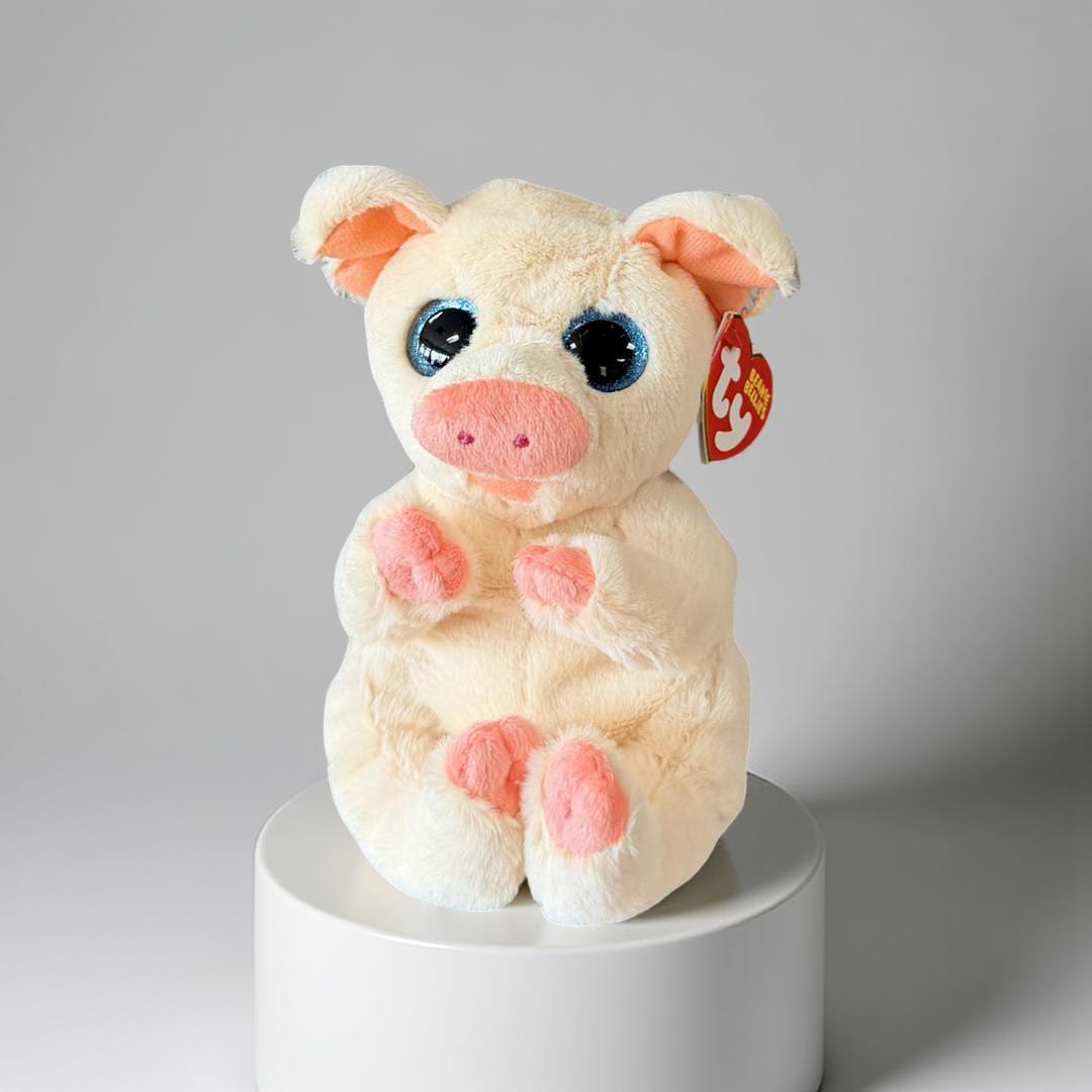 Penelope -  A soft, ivory-colored pig stuffed animal with large, blue glitter eyes and pink accents on its snout, inner ears, and feet. It sits upright in an attentive pose and is part of the Ty Beanie Bellies collection.This toy is commonly available in a regular 6-inch size.