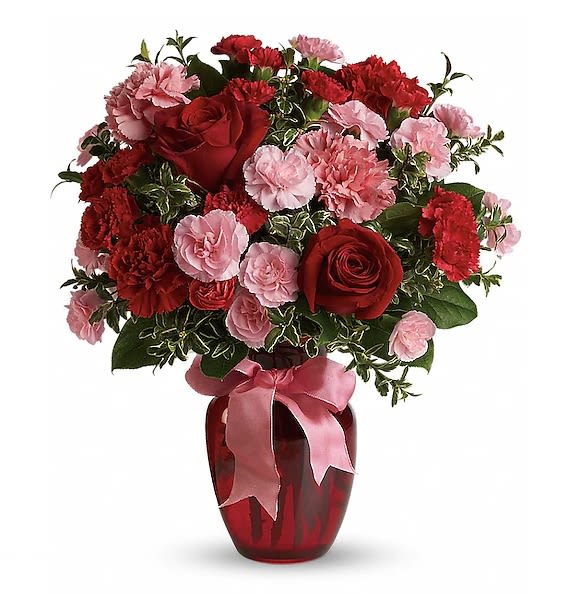 Dance with Me Bouquet - A delightful arrangement of  vibrant red rose and soft pink carnations paired with  elegant pink  spray roses, and complemented by lush green fillers  A mix of carnations and roses in shades of red and light pink. Delivered in a glass vase accented with pink satin ribbon.