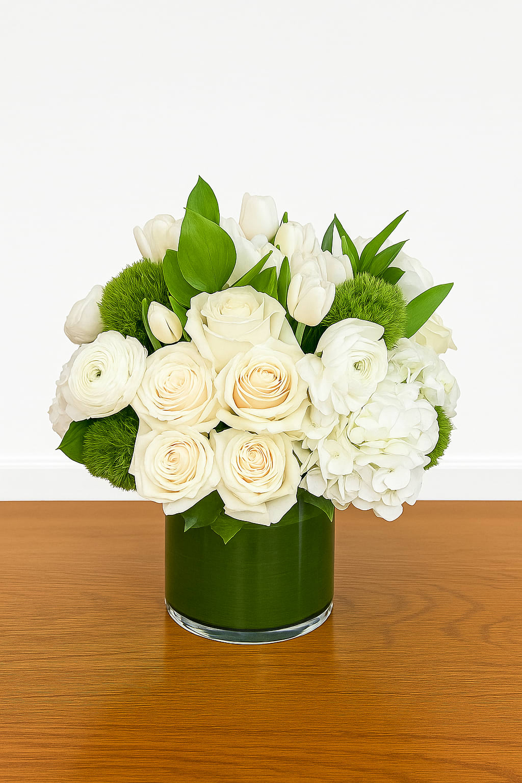 Modern Elegance - Clean, timeless, and effortlessly refined, Modern Elegance embodies sophistication in every petal. This luxurious white arrangement features roses, tulips, hydrangea, and lush greens designed in a sleek glass vase. Perfect for modern spaces, weddings, or sending a thoughtful gift of pure beauty.  Perfect for: weddings, sympathy, corporate gifts, or minimalist decor.