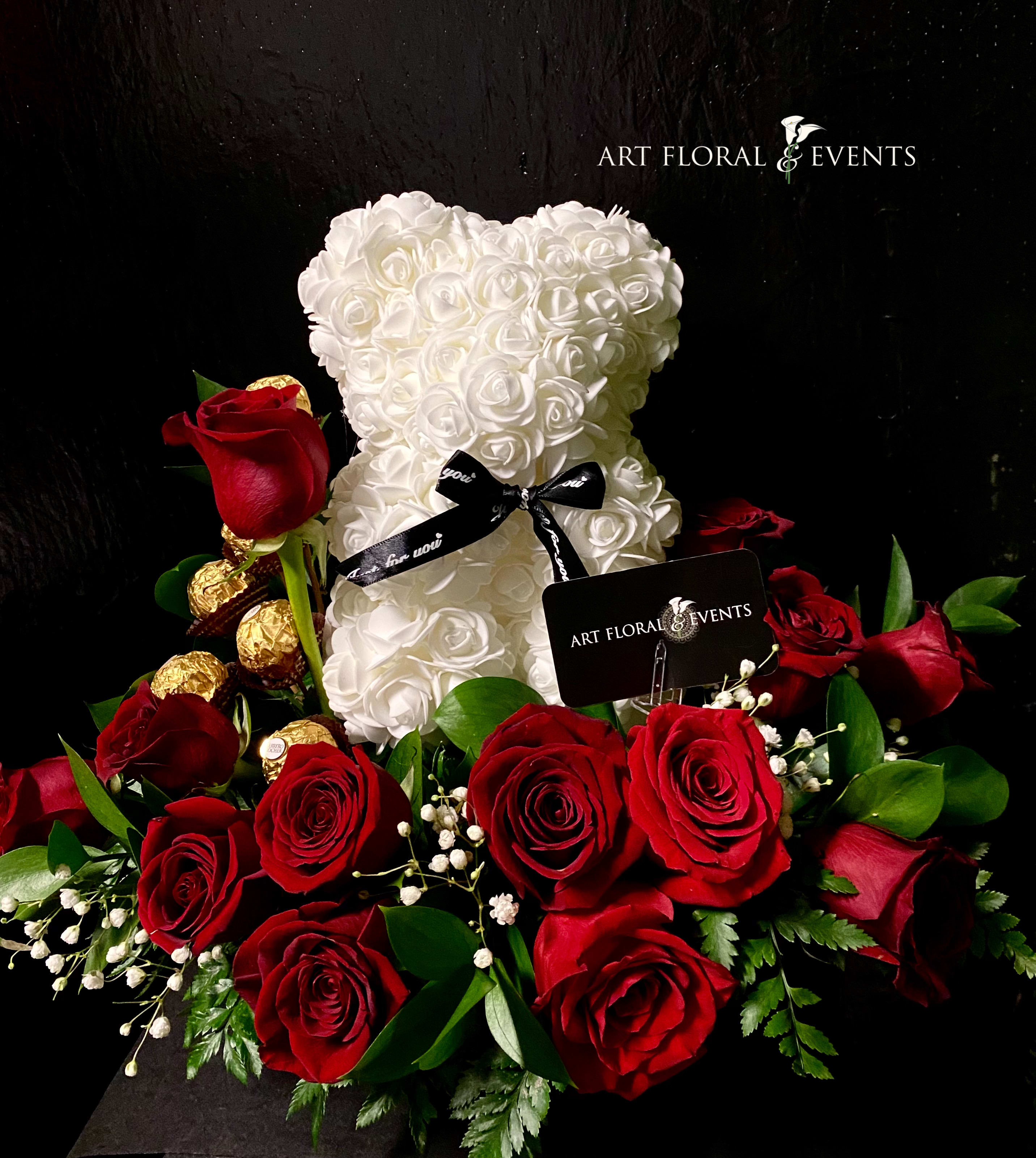 Rosebear in Roses - White bear embellished in artificial roses, in a bed of 24 fresh red roses, with ferrero rocher chocolates . 