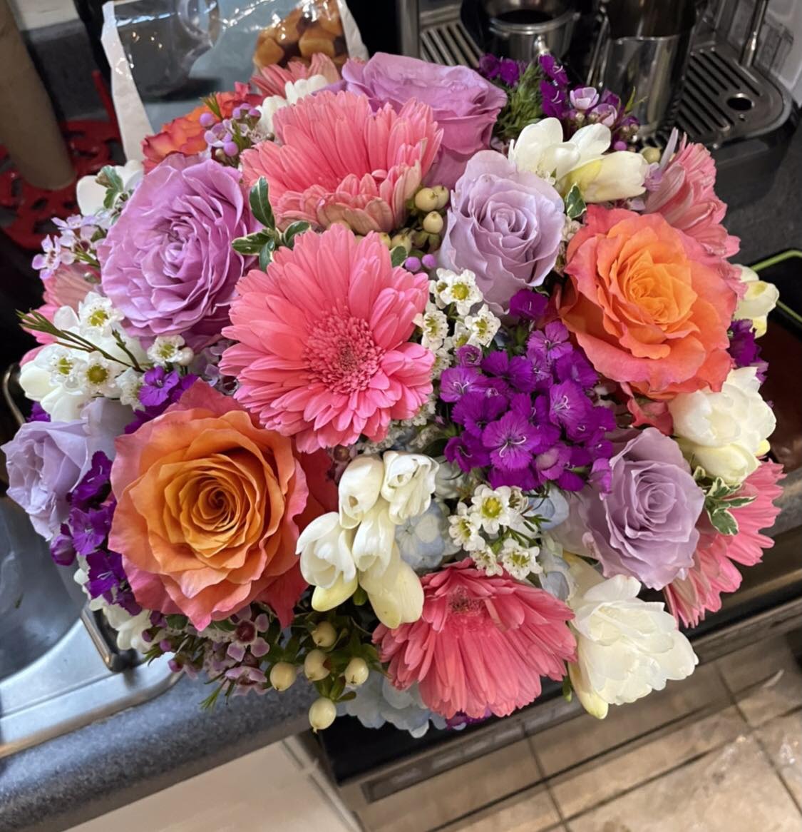 Petal Pop - Petal Pop is a bright, low and compact designer's choice floral arrangement featuring vibrant, seasonal blooms. Designed to add a cheerful burst of color, it’s perfect for desks, coffee tables, and smaller spaces.
