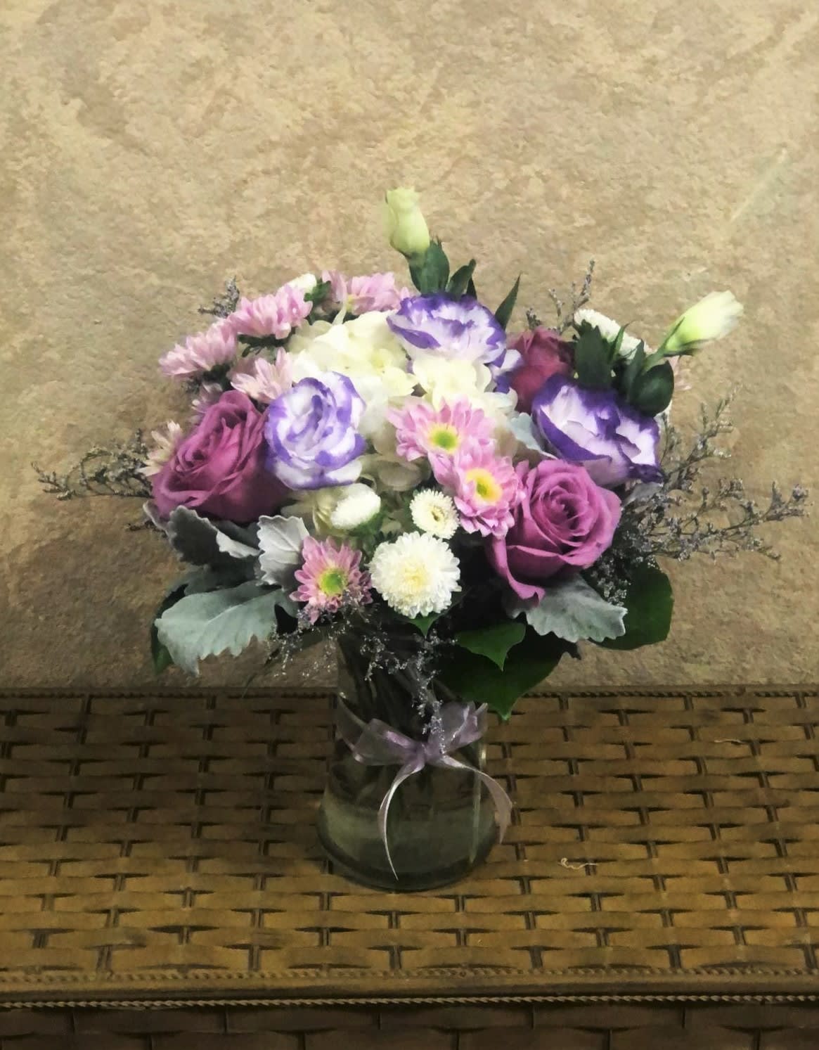 Subtle Lavender - Recipe: White Hydrangeas, Lavender Roses, White and Purple Lisianthus, Purple Daisies, White Chrysanthemums, and Dusty Miller in a 6.5" h x 4" mouth vase. Availability: All year round Orientation: All Facing View Photo shown: Standard