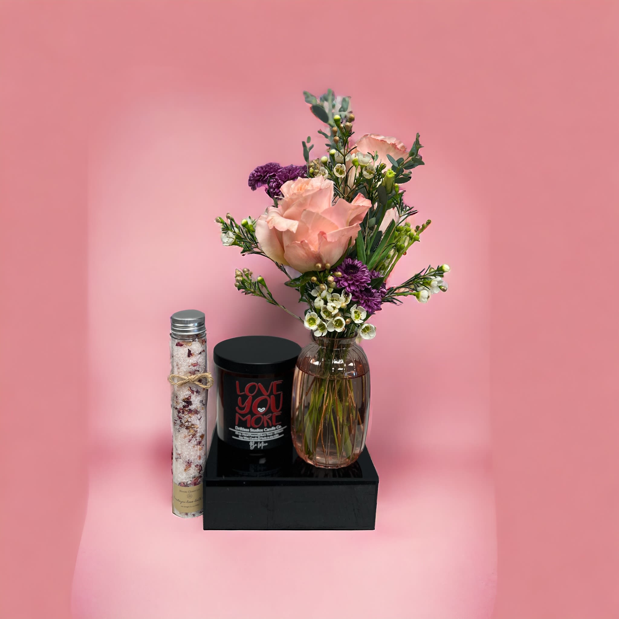 Be Mine Trio - Bundle includes 10 oz. Candle with hints of champagne, candy, strawberry, cream, sugar and musk. Bud vase with two roses and fillers. 3.1 oz Luxurious bath salt tube