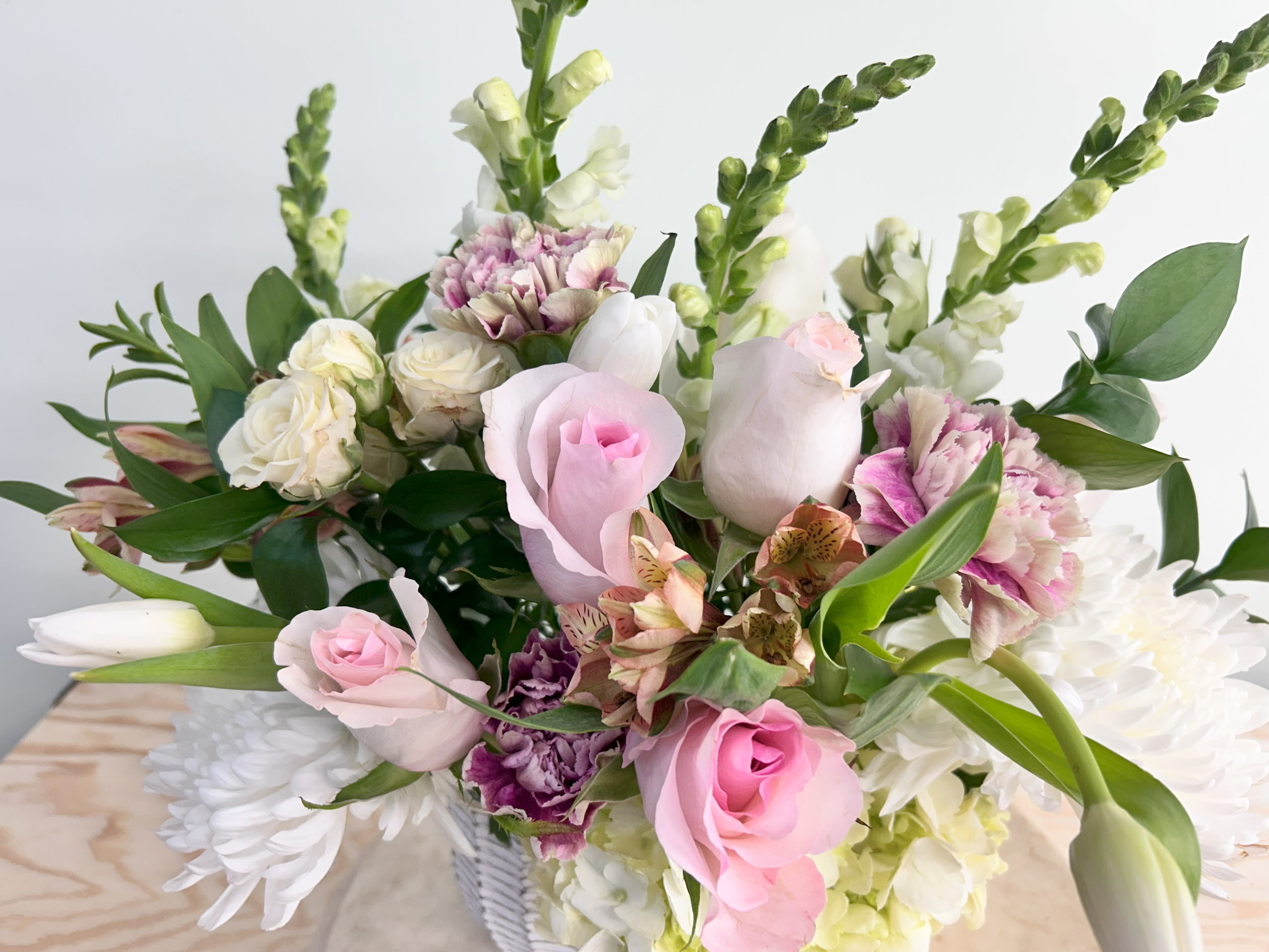 2026 Valentine's Ceramic Basket of Flowers - A lovely ceramic basket with flowers. Roses, tulips, hyacinth, and other filler flowers and greens. Can be ordered for delivery the week of Valentine's Day.