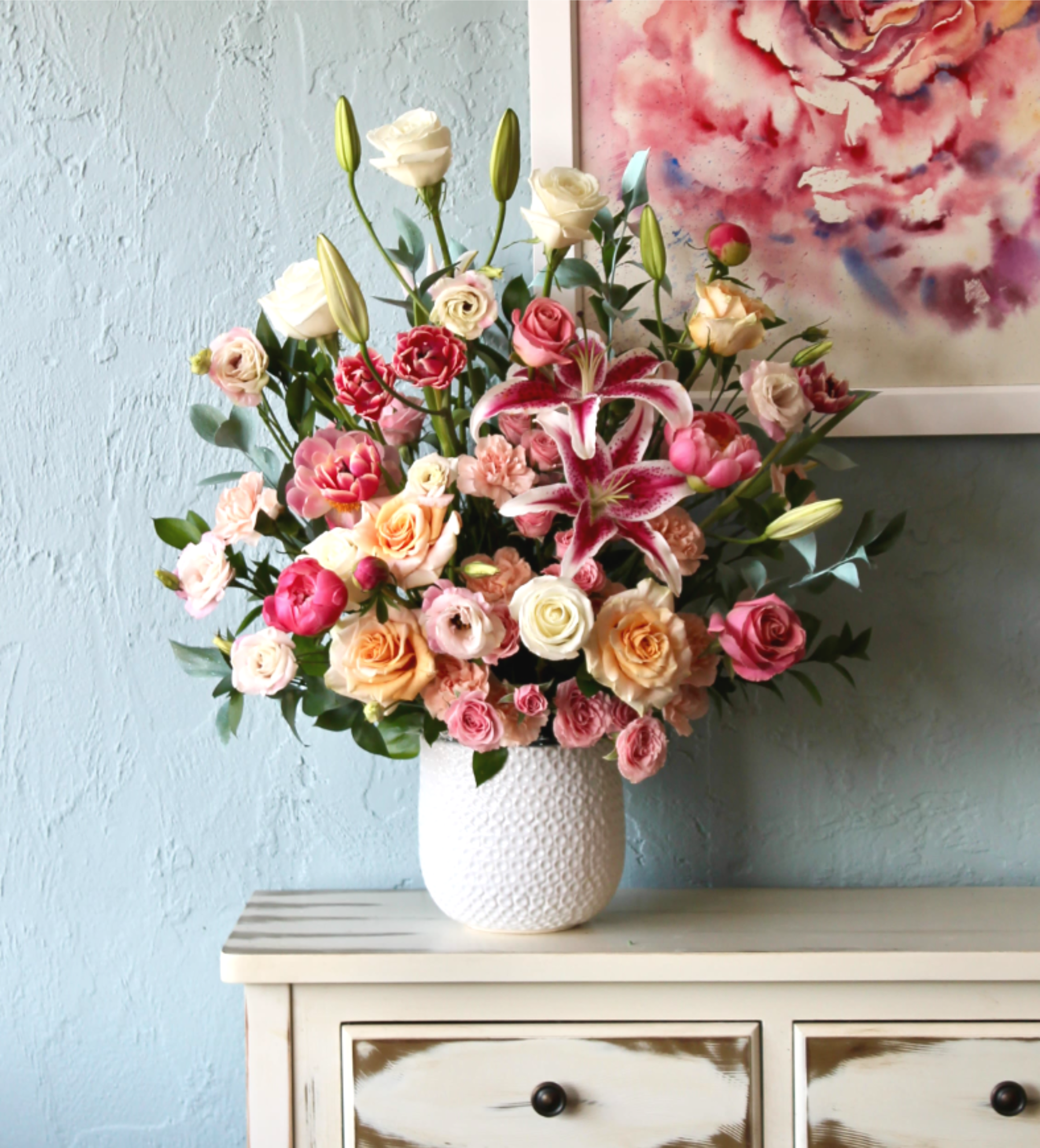 Lily Pop - We incorporate a lots of love in this arrangement, using the only   fresh flowers from organic partner farms around.  Featuring Stargazer Lilies (not recommended for homes with cats), and snapdragons, this arrangement makes a beautiful summer birthday present or a lovely congratulations gift.  Approximate Dimensions: 15"D x 27"H