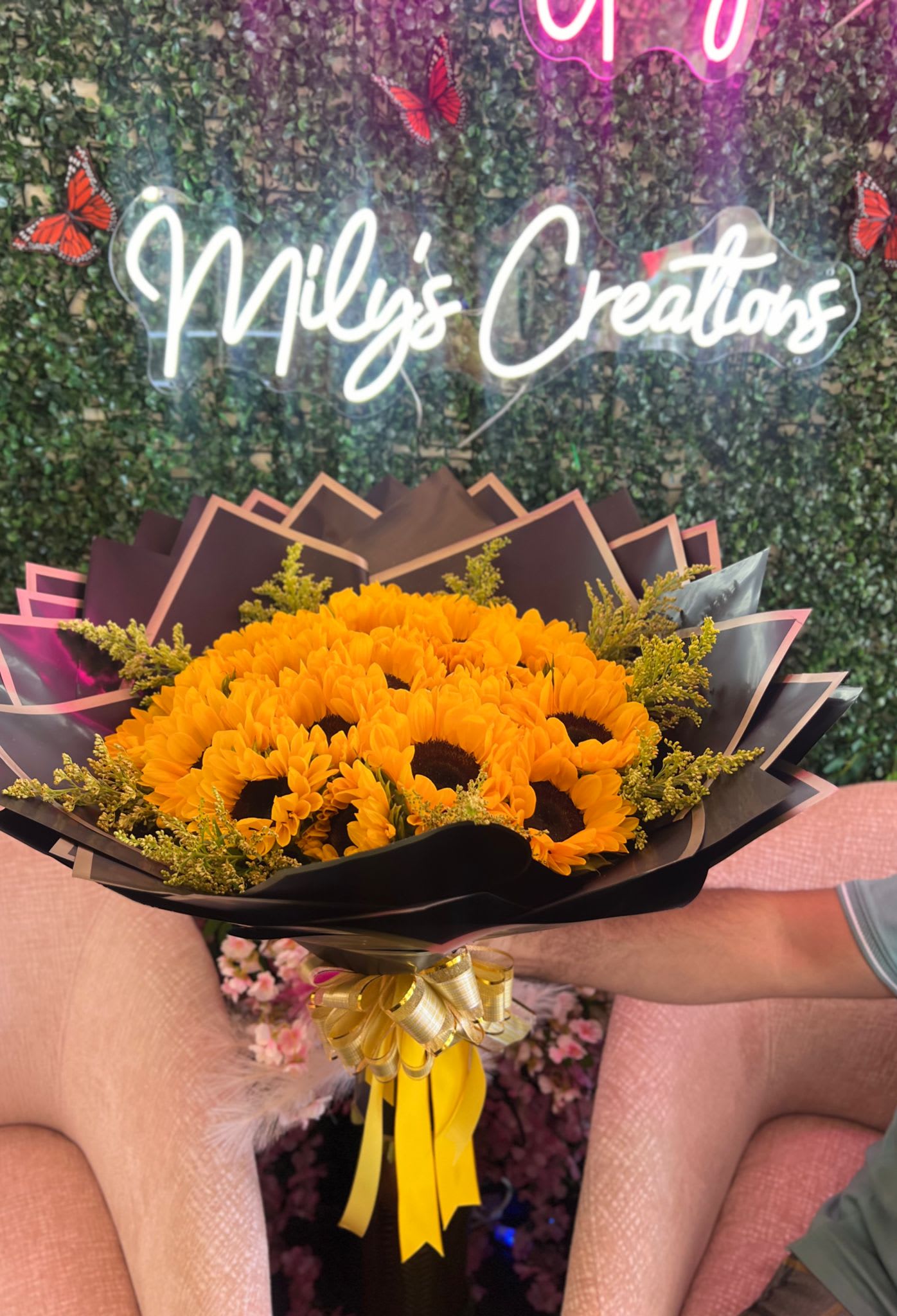 Sunflower Wrapped Bouquet - Thoughtful selection of sunflowers and warm-toned flowers that capture the essence of sunny summer days. The goal is to reflect the warmth, brightness, and cheerful ambiance of the season. Wrapped with elegant waterproof paper. 