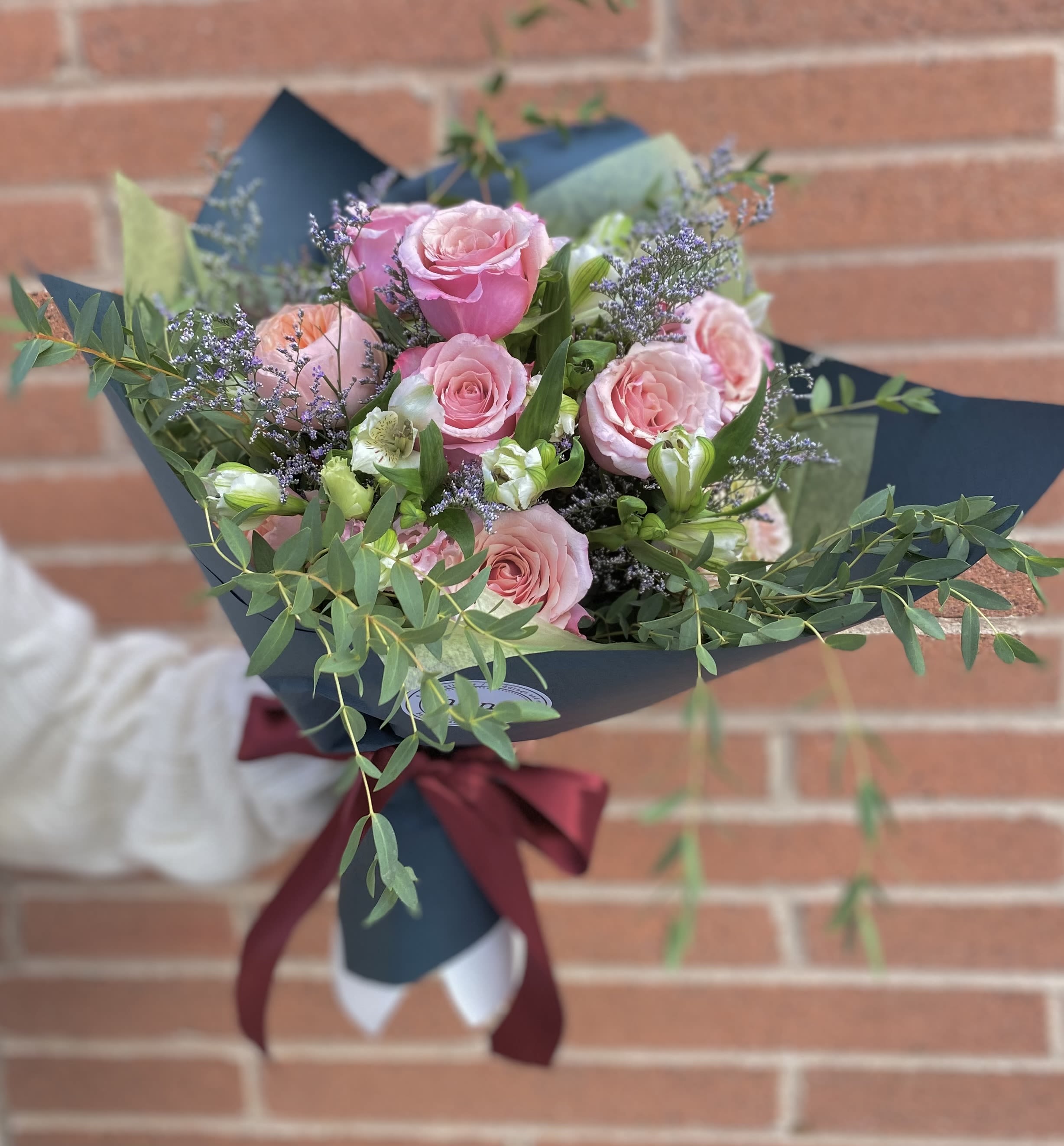Rose Garden ( Wrapped Bouquet)  - Designer's Choice  Pink, Peach or Purple Roses with other flowers and greenery 
